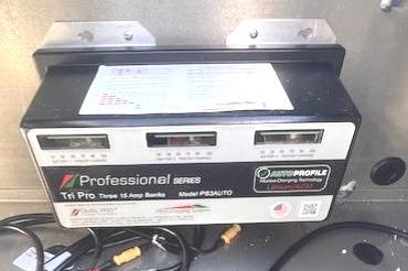 Battery charger in a 2026 Ranger RT188P boat, featuring multiple cables and connections.
