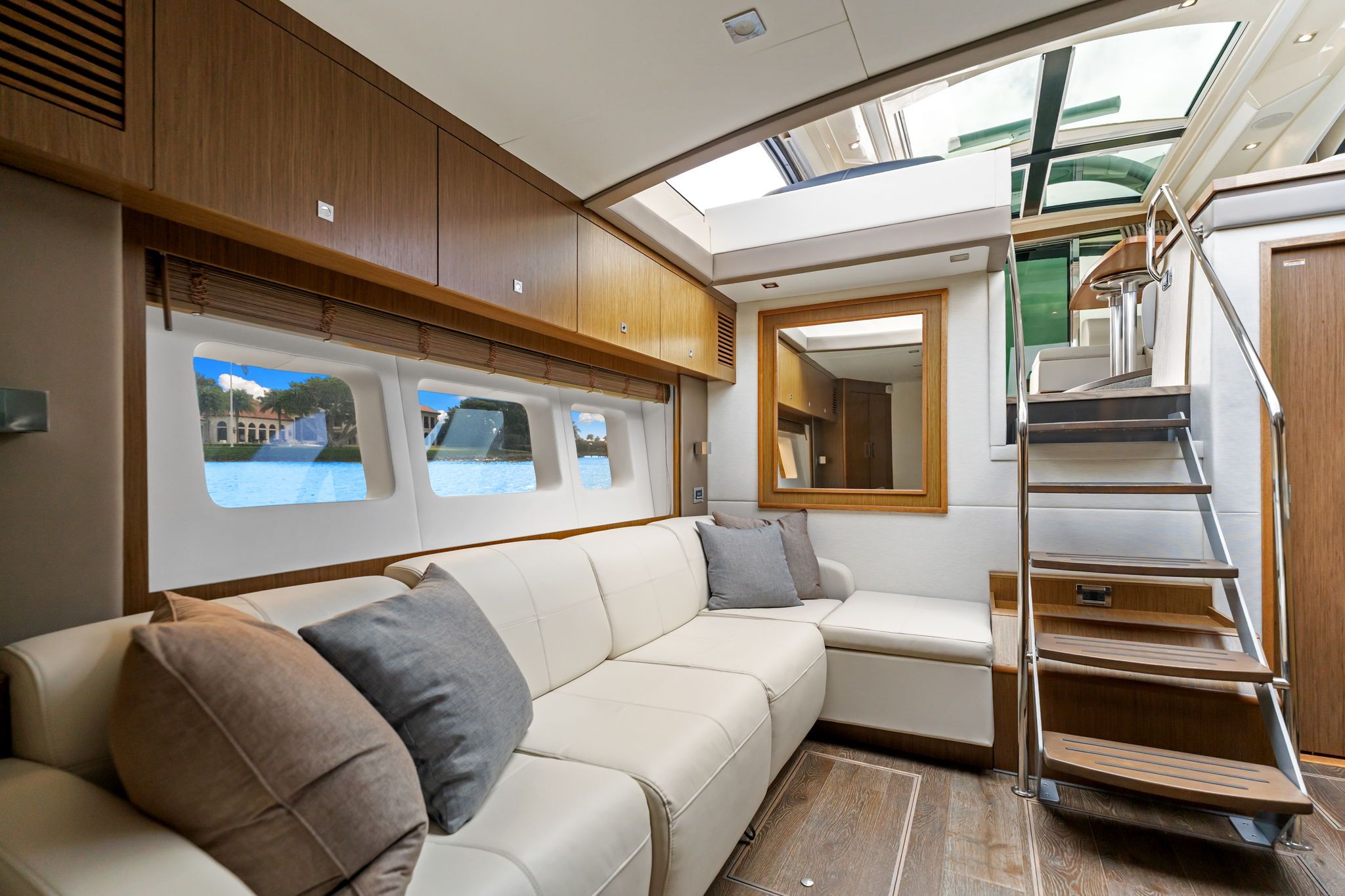 Interior of the 2017 Sea Ray Sundancer 510 with elegant furnishings and large windows.