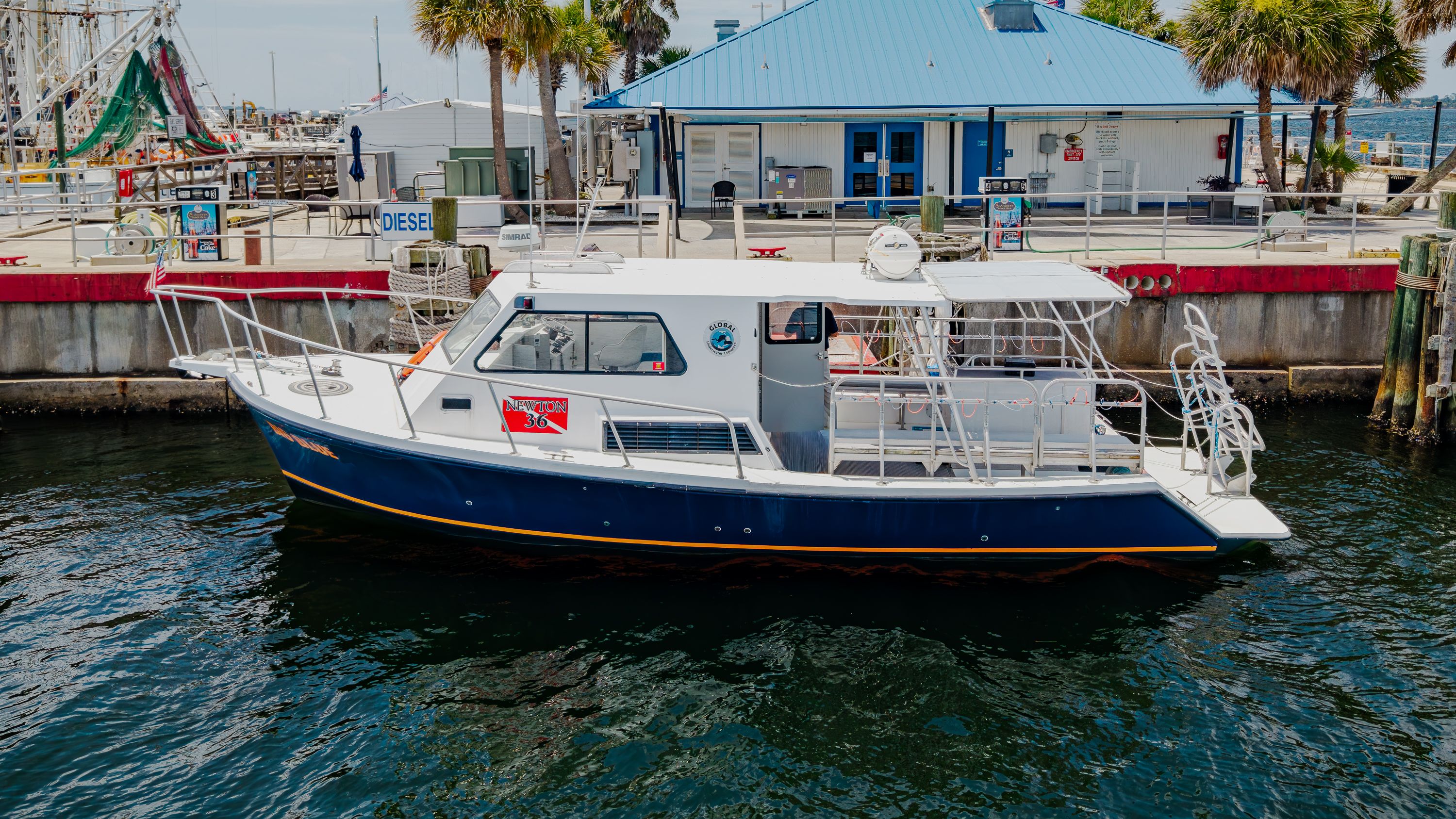 A 2019 Newton 36' Dive Special boat docked at a harbor.