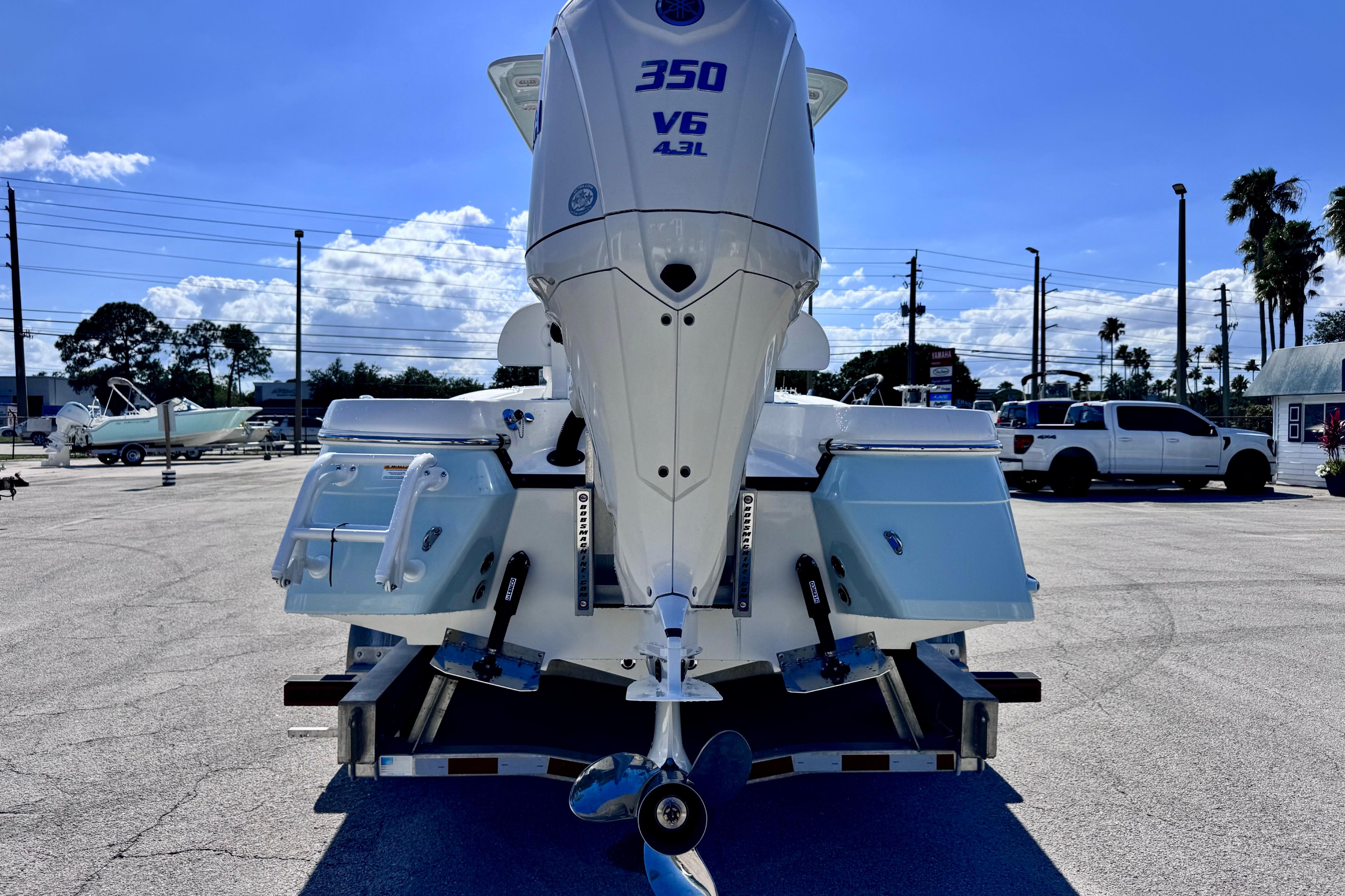 2026 BlackJack 256 Coastal boat with powerful 350 V6 engine, parked outdoors.