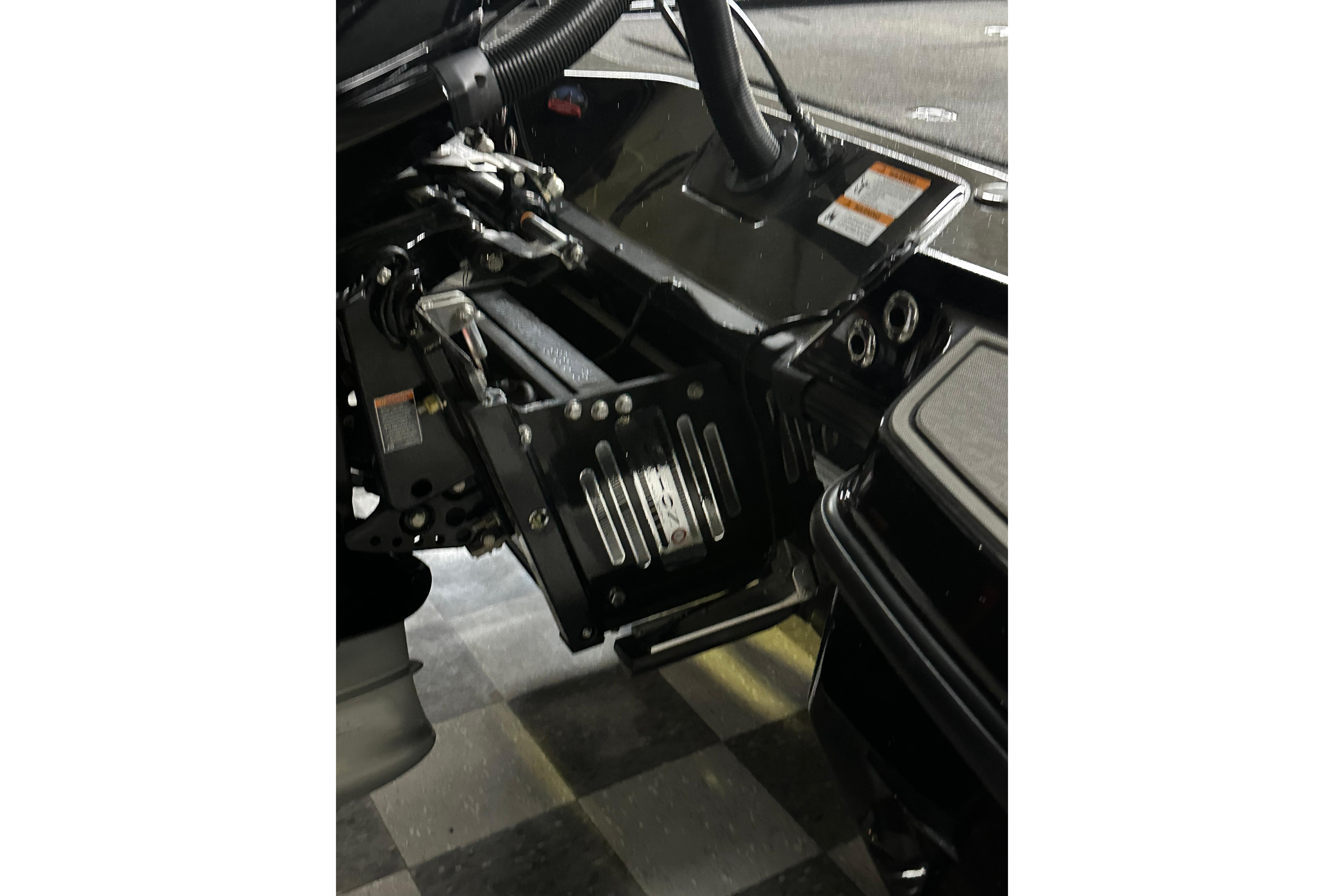Interior view of 2025 Triton 21XP Patriot boat, showcasing steering and control mechanisms.