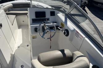 2022 Key West 239 DFS boat interior with steering wheel and seating.