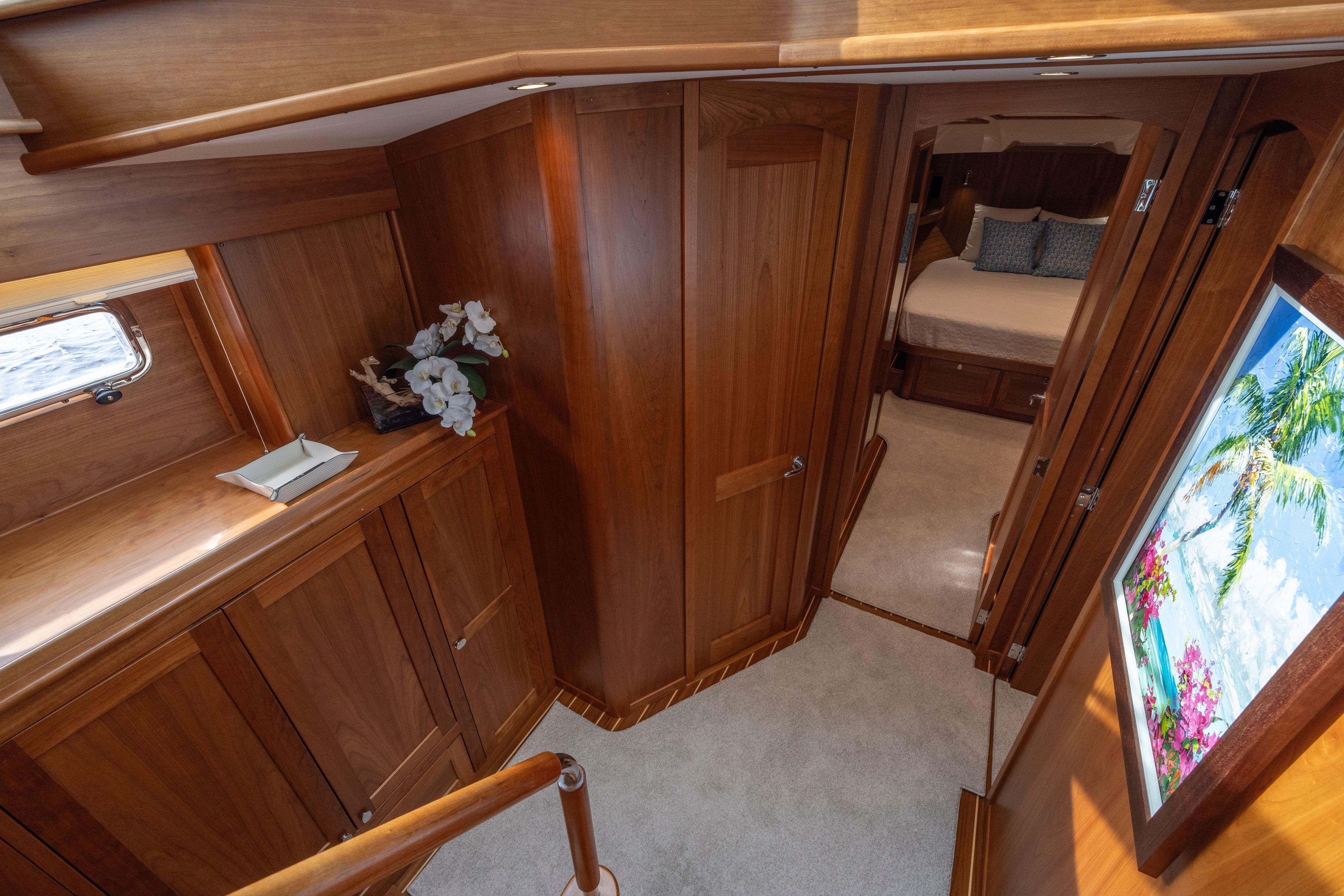 Luxurious interior of 2026 Sabre 58 Salon Express yacht with wood paneling and cozy bedroom.