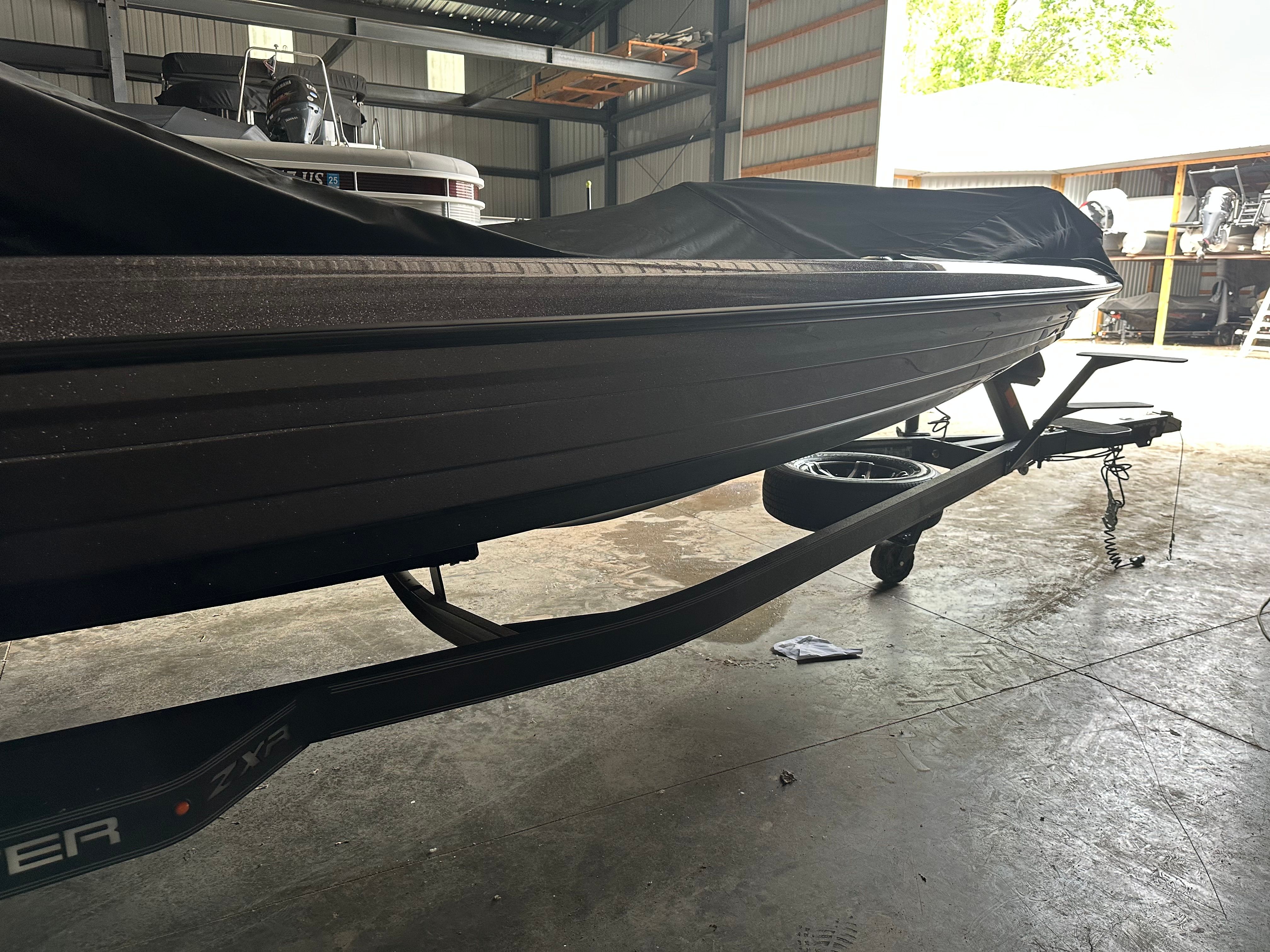 2024 Skeeter ZXR21 boat on trailer in warehouse.