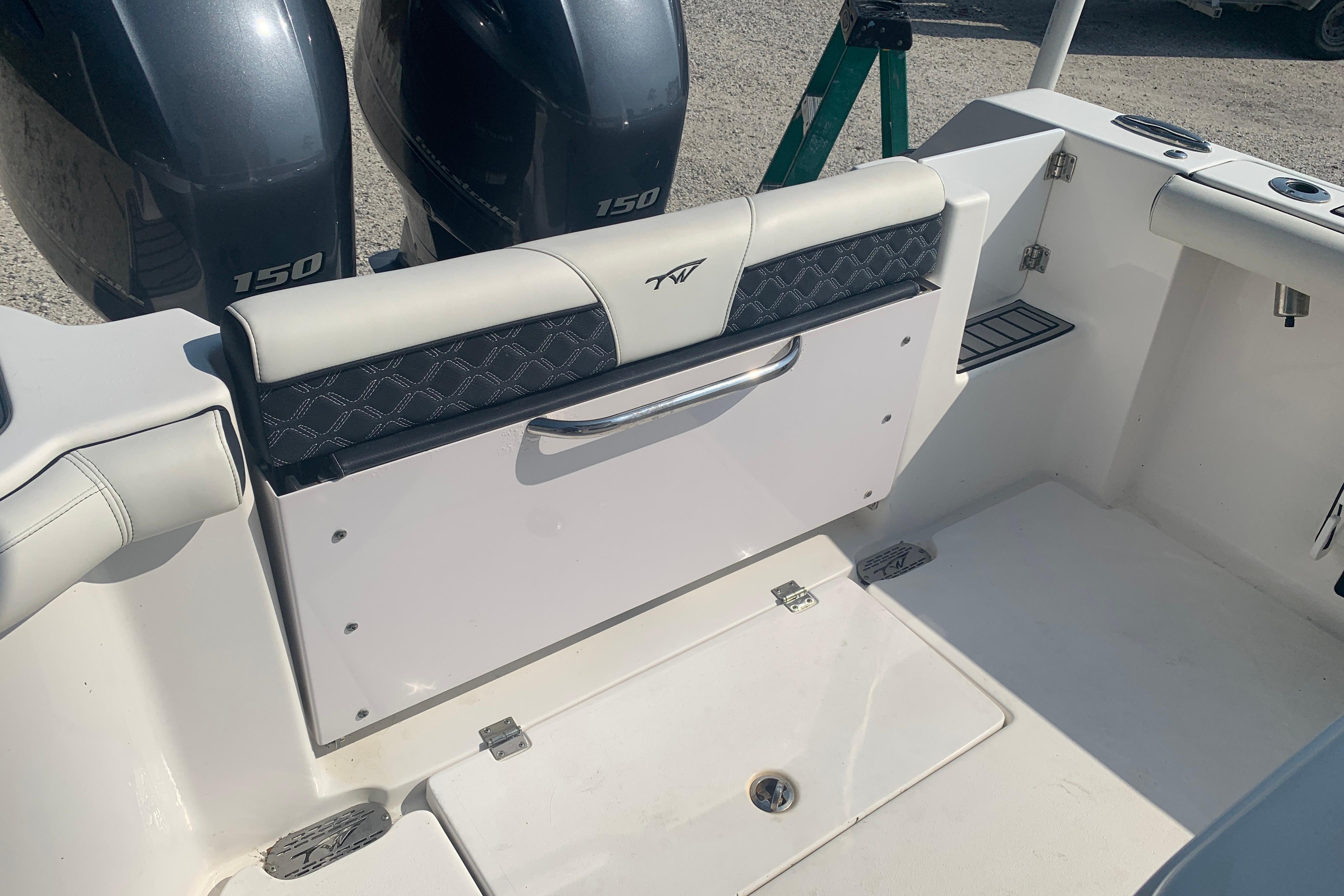 2021 Tidewater 256 CC Adventure boat interior with dual 150 engines and seating area.