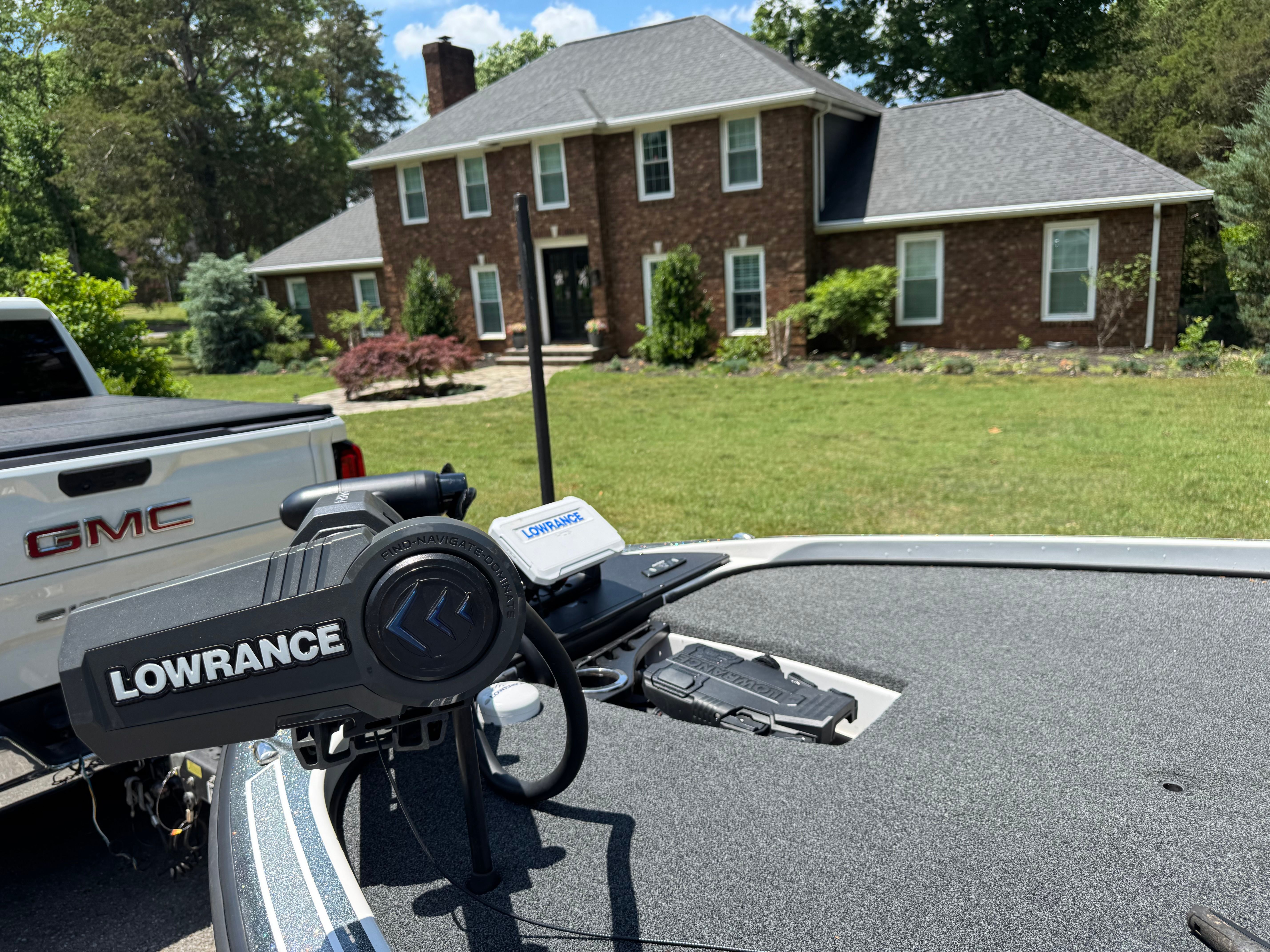 Nitro Z21 boat with Lowrance equipment in front of a house, 2019.