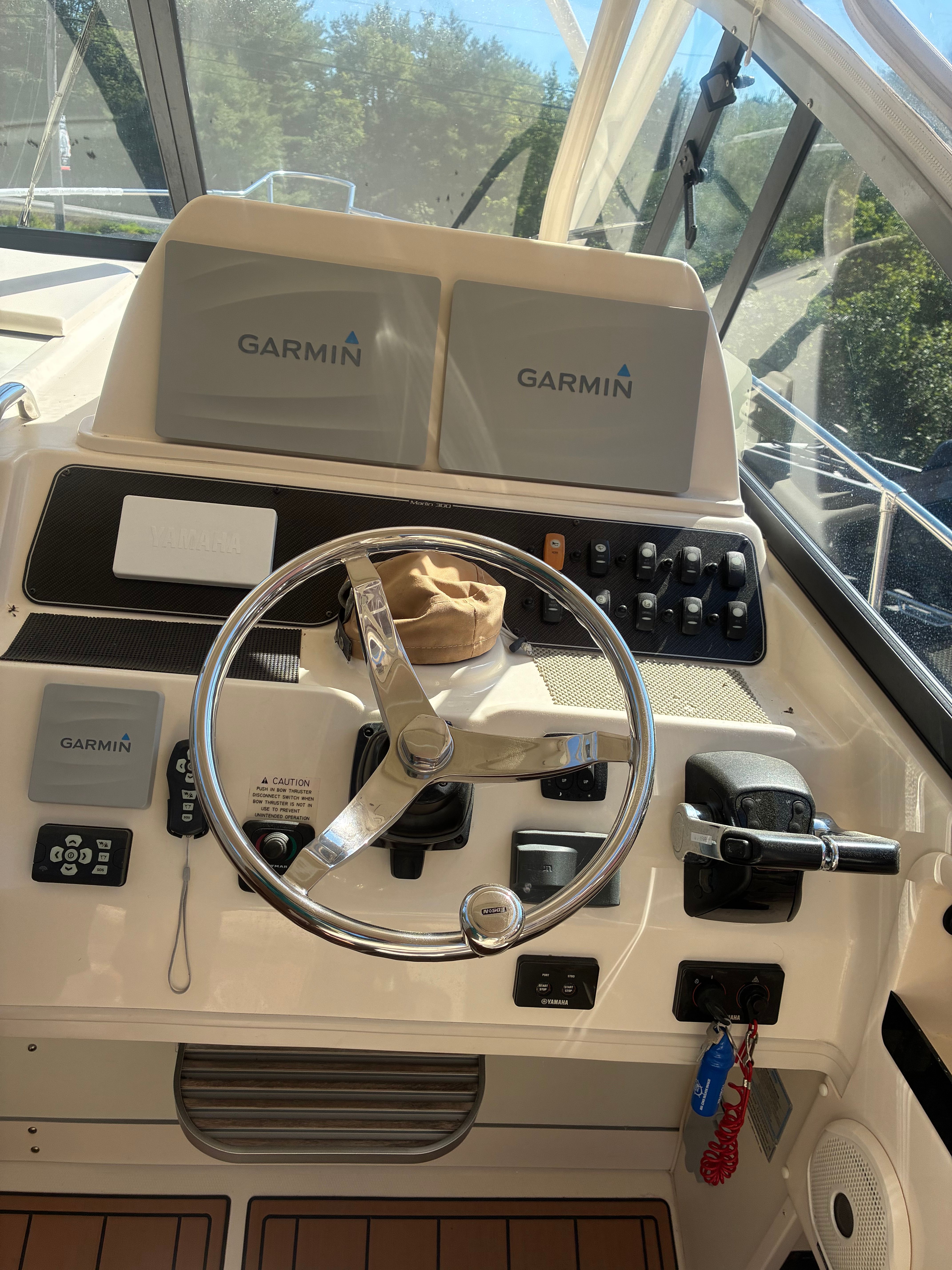 The cockpit of a 2017 Grady-White Marlin 300 with Garmin electronics and a steering wheel.