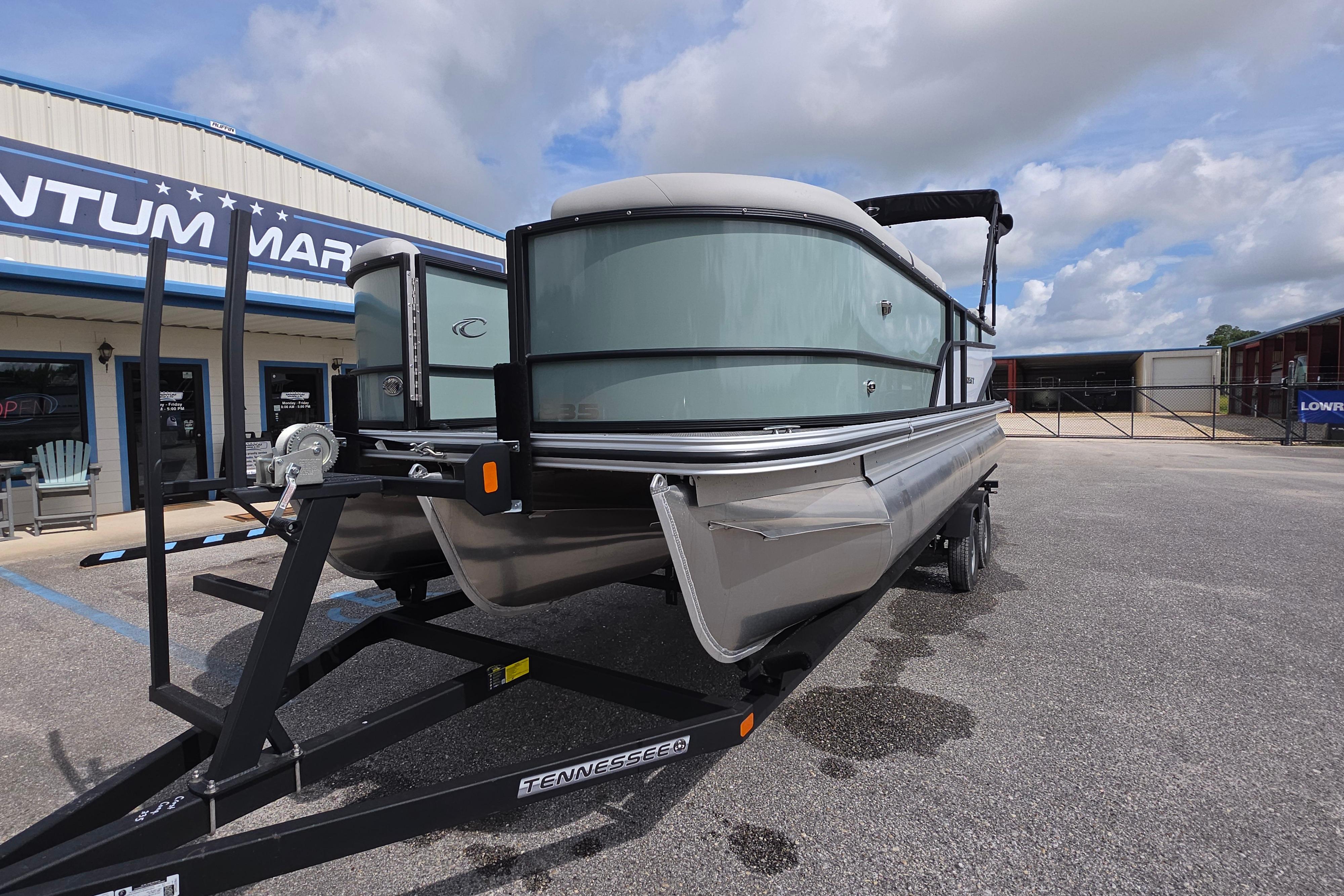 2026 Crest 235 Conquest SLC pontoon boat on trailer at dealership.