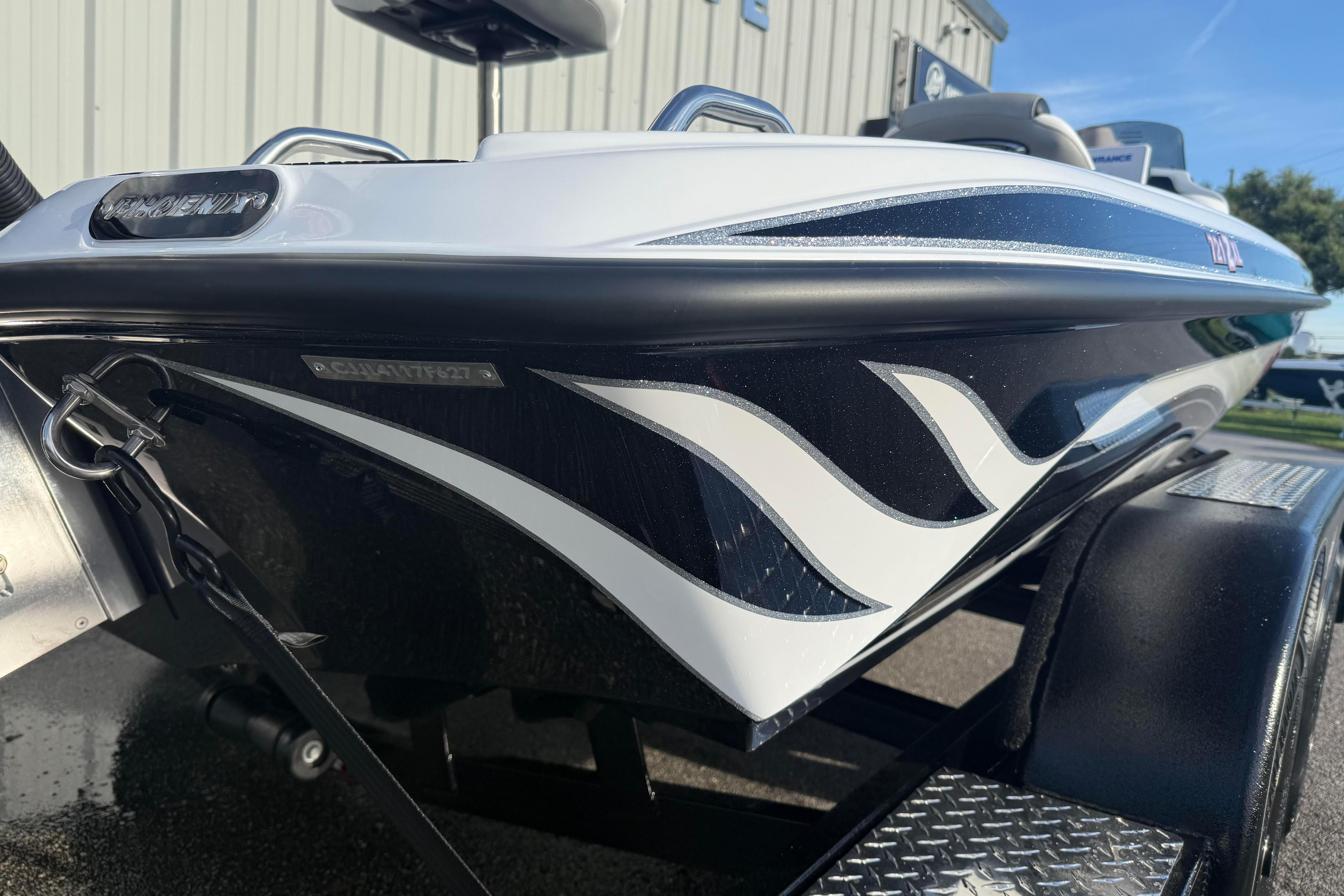 2027 Phoenix 721 ZXL boat with sleek black and white design, parked on a trailer.