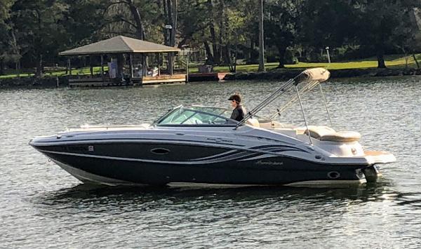 2012 Godfrey Hurricane boat on a calm lake.