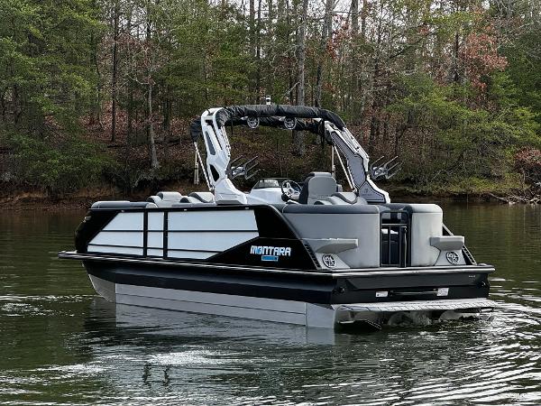 2025 Montara Surf Boss 2.0 25 pontoon boat on a serene lake.
