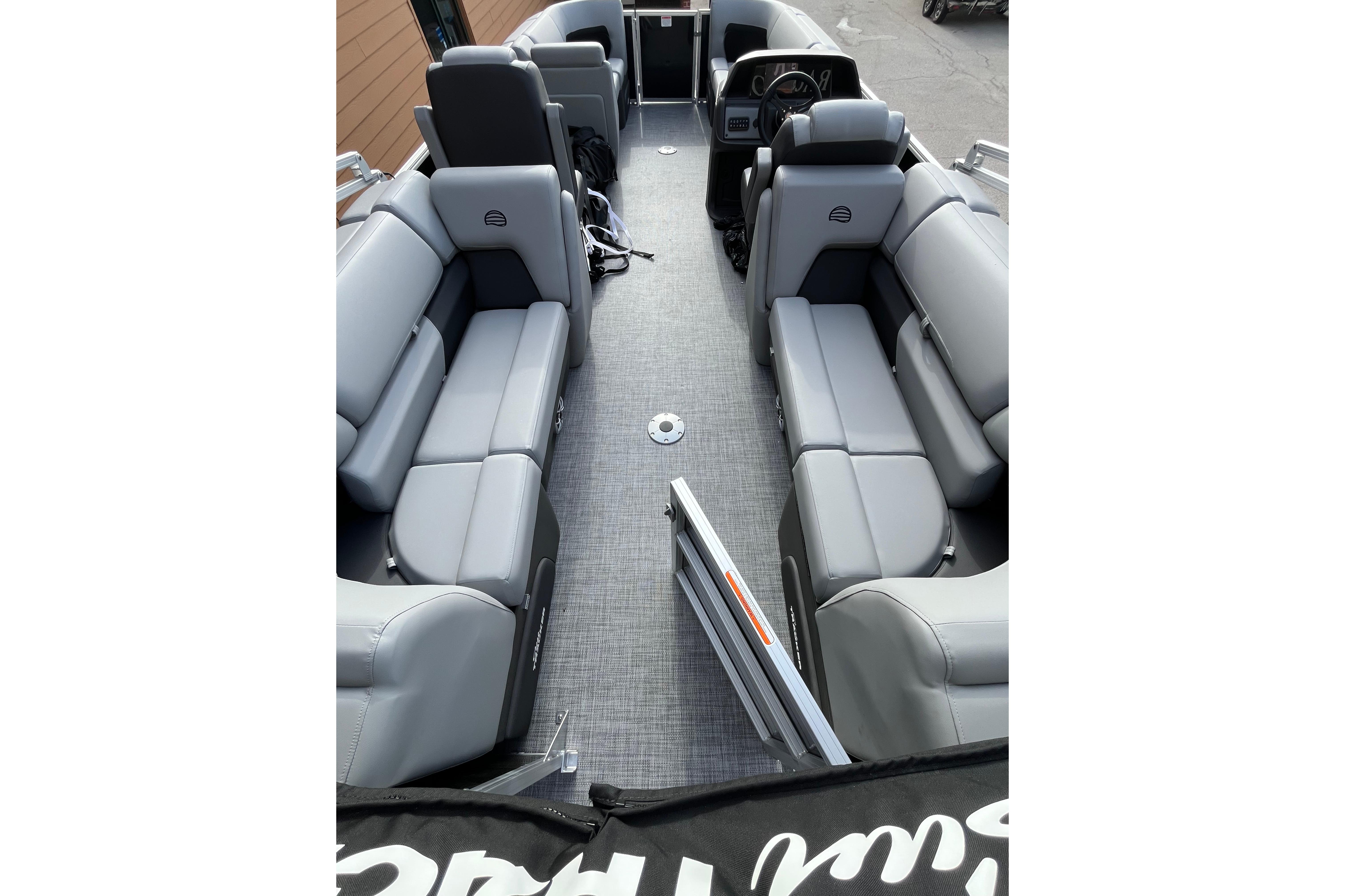 2026 Sun Tracker Party Barge 22 DLX interior with gray seating and spacious layout.