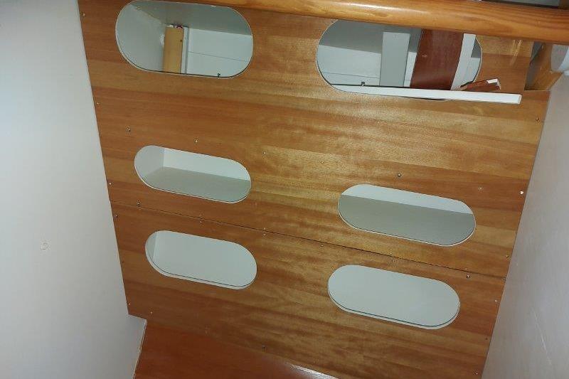 Wooden interior panel with oval cutouts on a 2017 Bruce Roberts Spray boat.