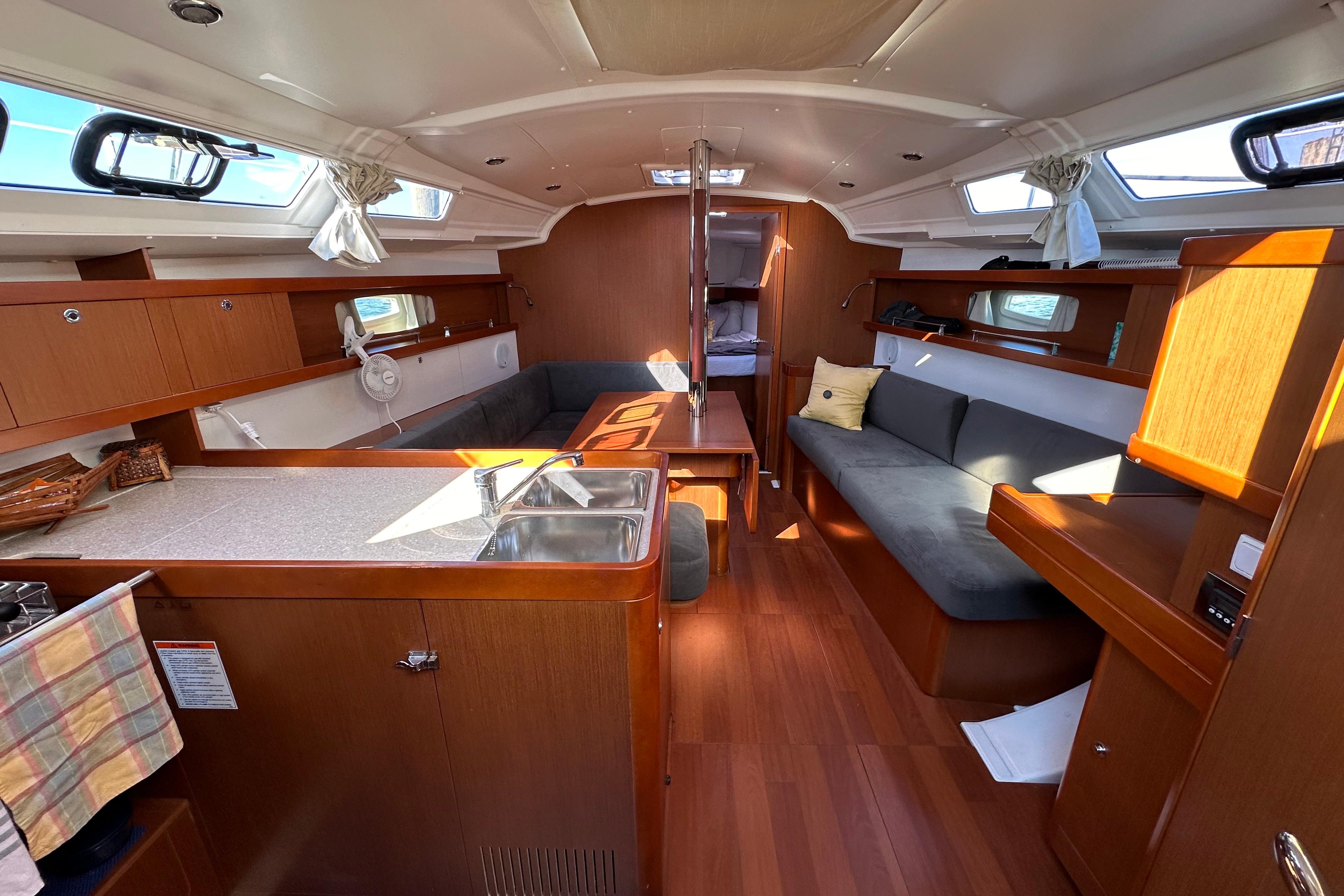 Interior of 2015 Beneteau Oceanis 37 sailboat with modern wood finish and seating area.