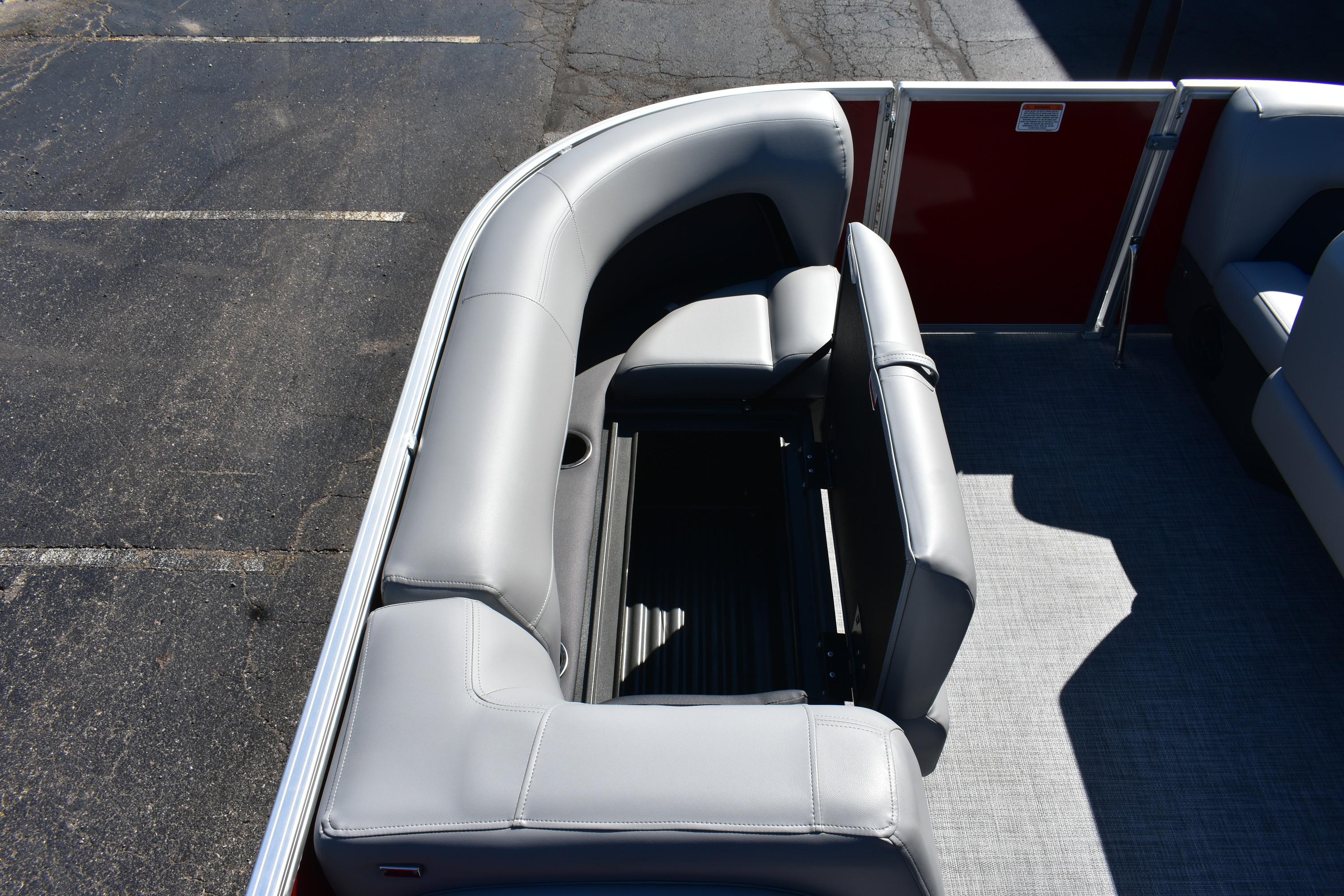 2026 Sun Tracker Party Barge 18 DLX interior with gray seating and storage.