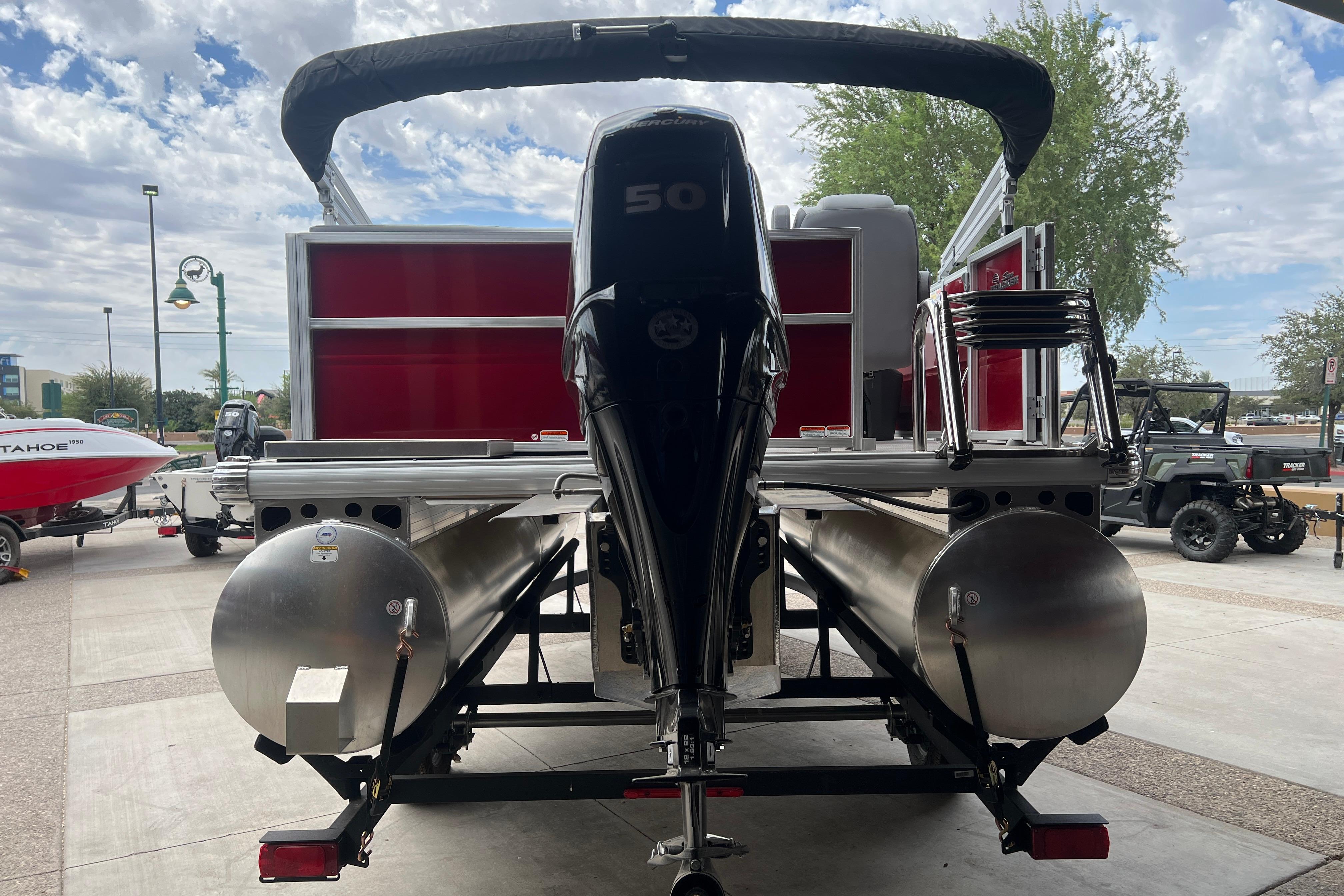 2026 Sun Tracker Party Barge 16 DLX pontoon boat with powerful outboard motor.