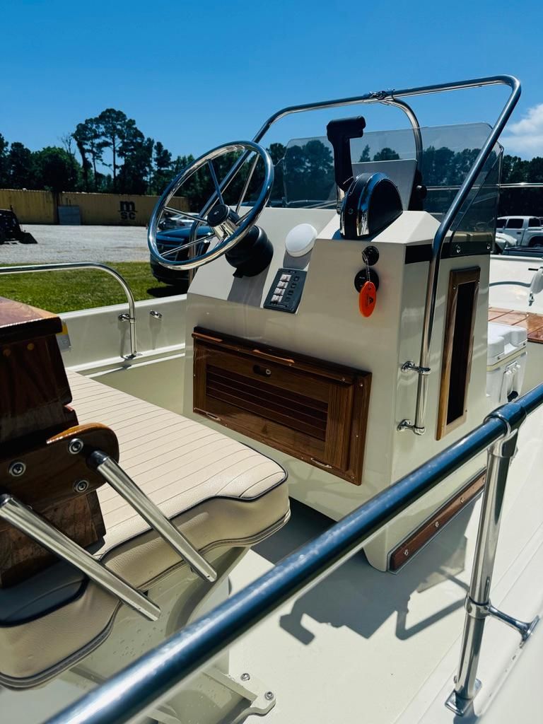 The image shows the cockpit of a 1986 Boston Whaler 17 Montauk with a helm and seating.