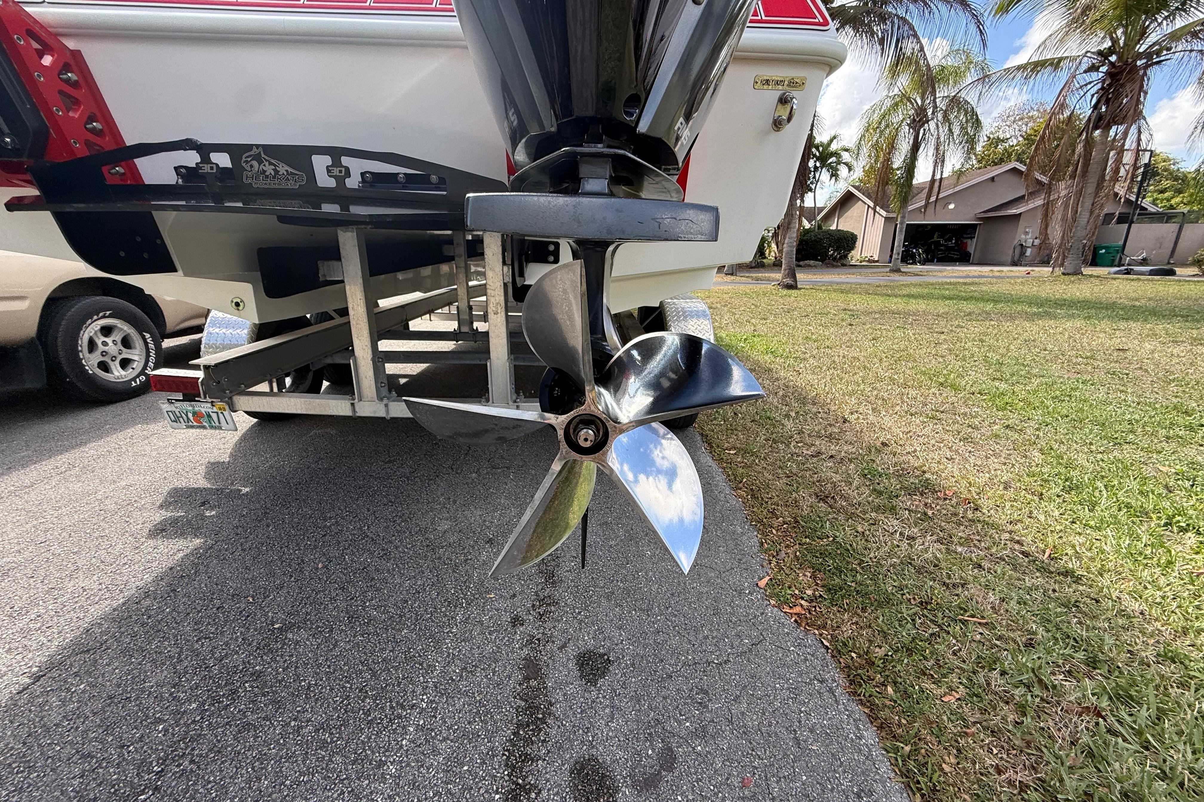 2020 HellKats 30 boat propeller on trailer, parked near palm trees.