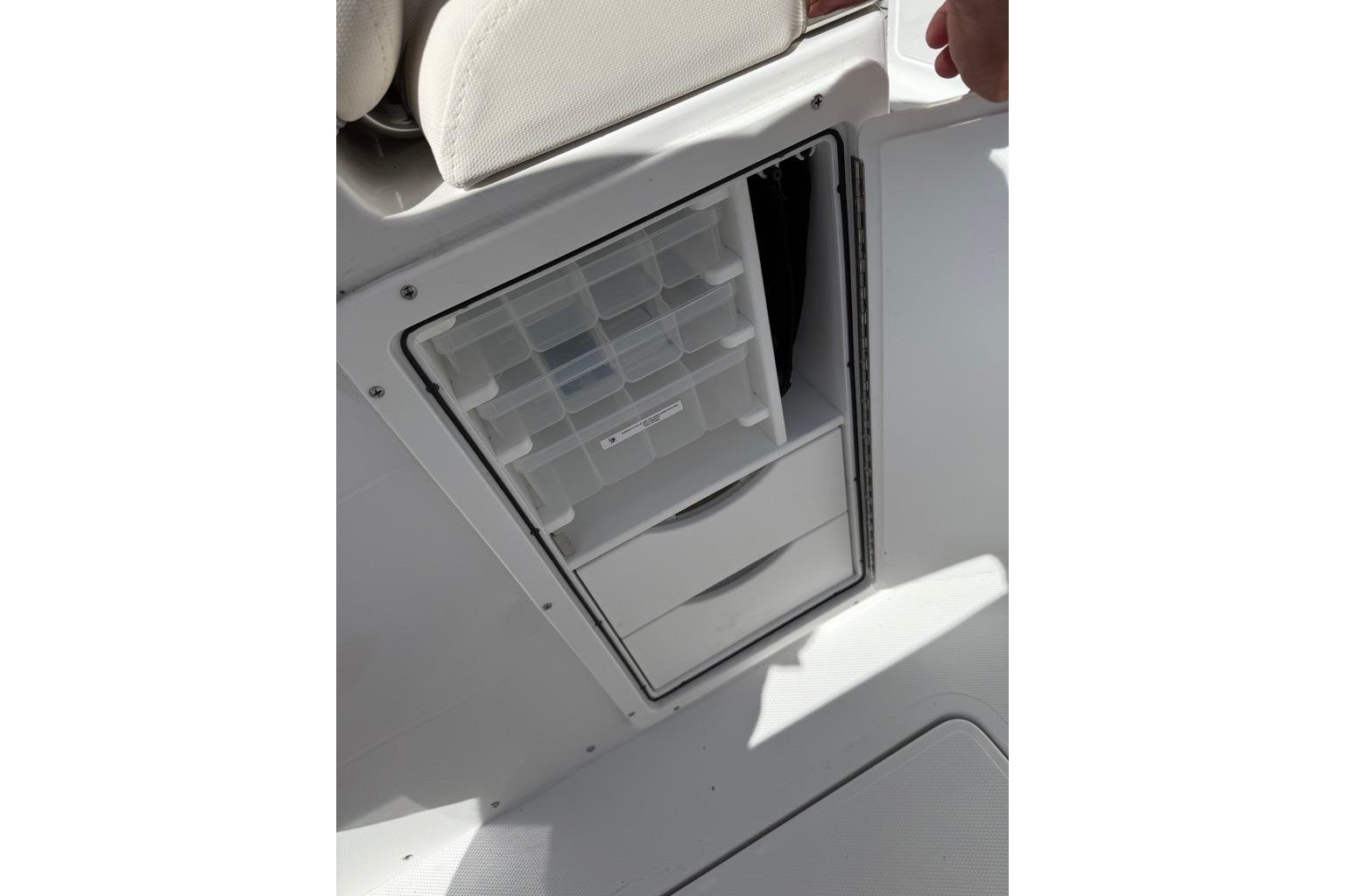Storage compartment on 2026 Sea Hunt Ultra 285 Coffin Box boat, featuring organized drawers.
