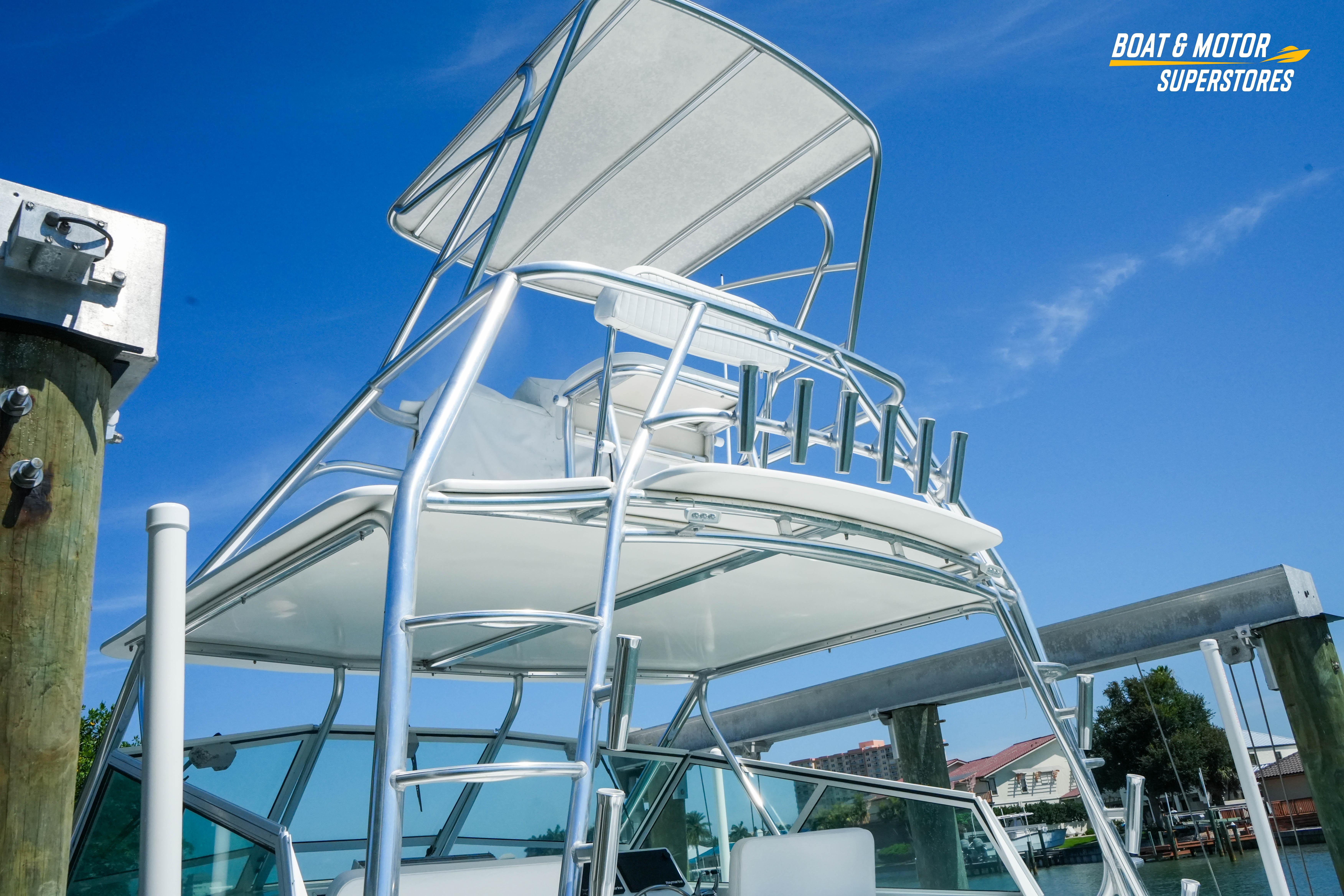 1986 Topaz 37 boat with tower, docked under clear blue sky.