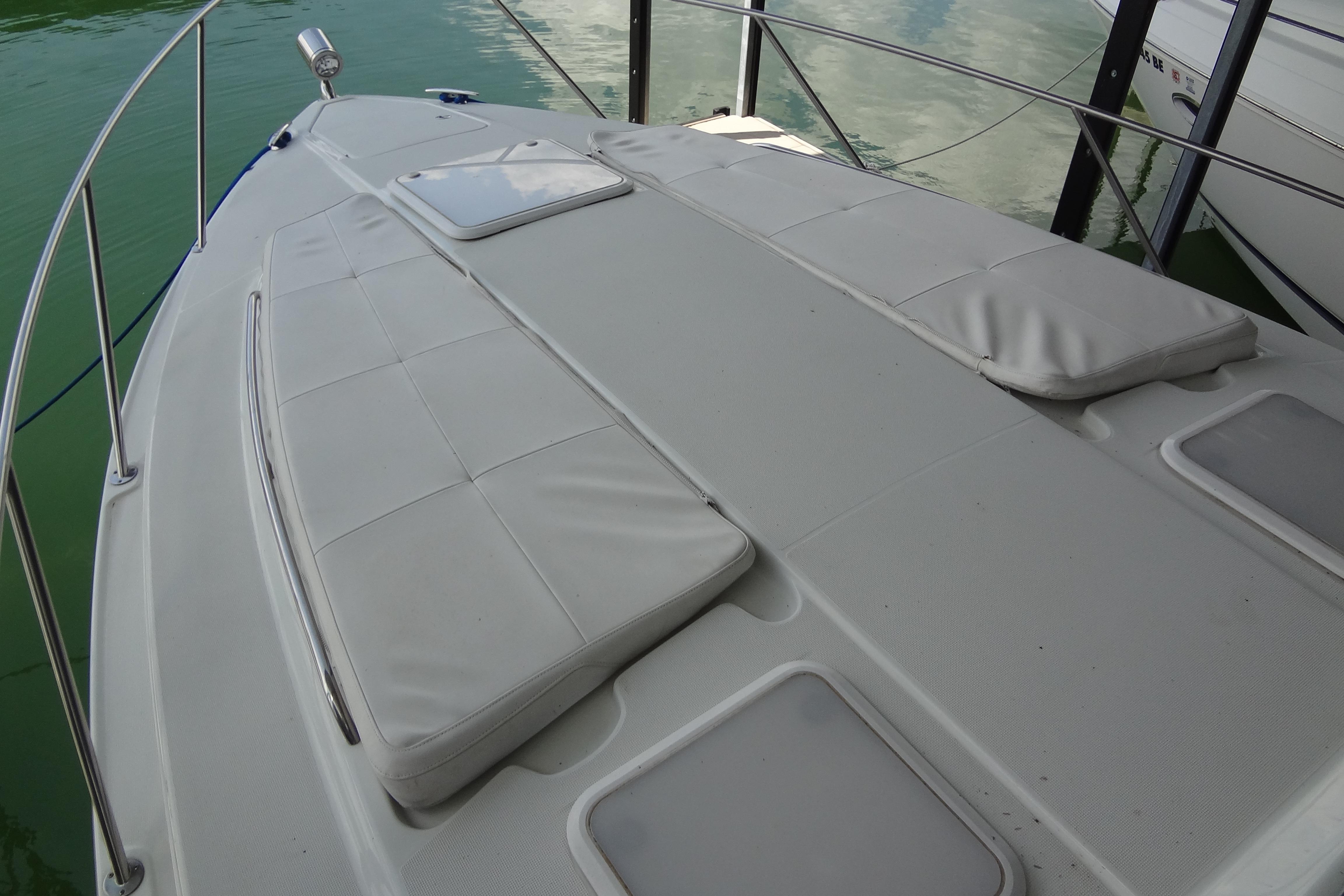 2007 Formula 34 Performance Cruiser bow with cushioned seating, docked on calm water.