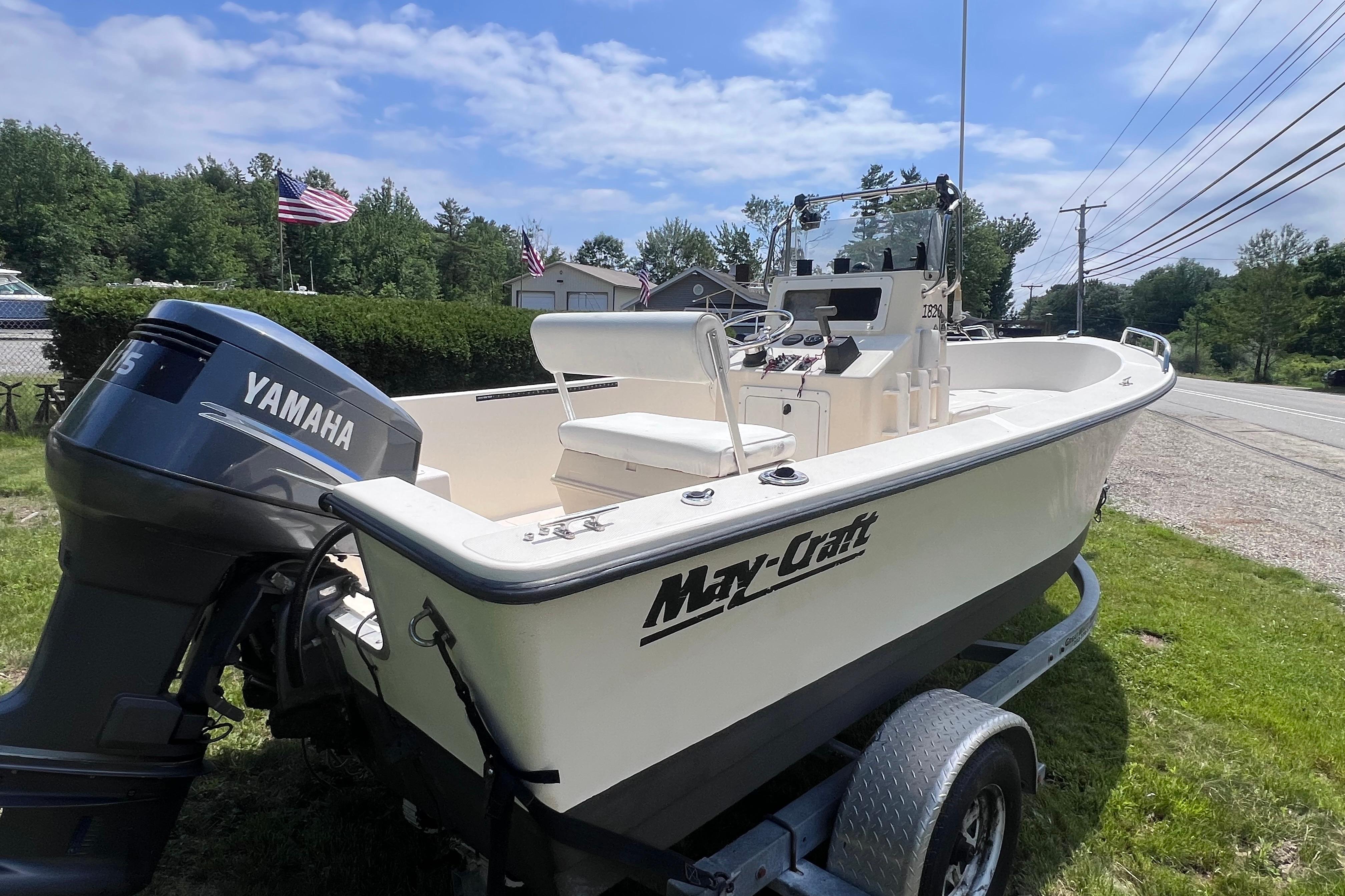 2003 May-Craft 1820CC boat with Yamaha motor on trailer, parked outdoors.