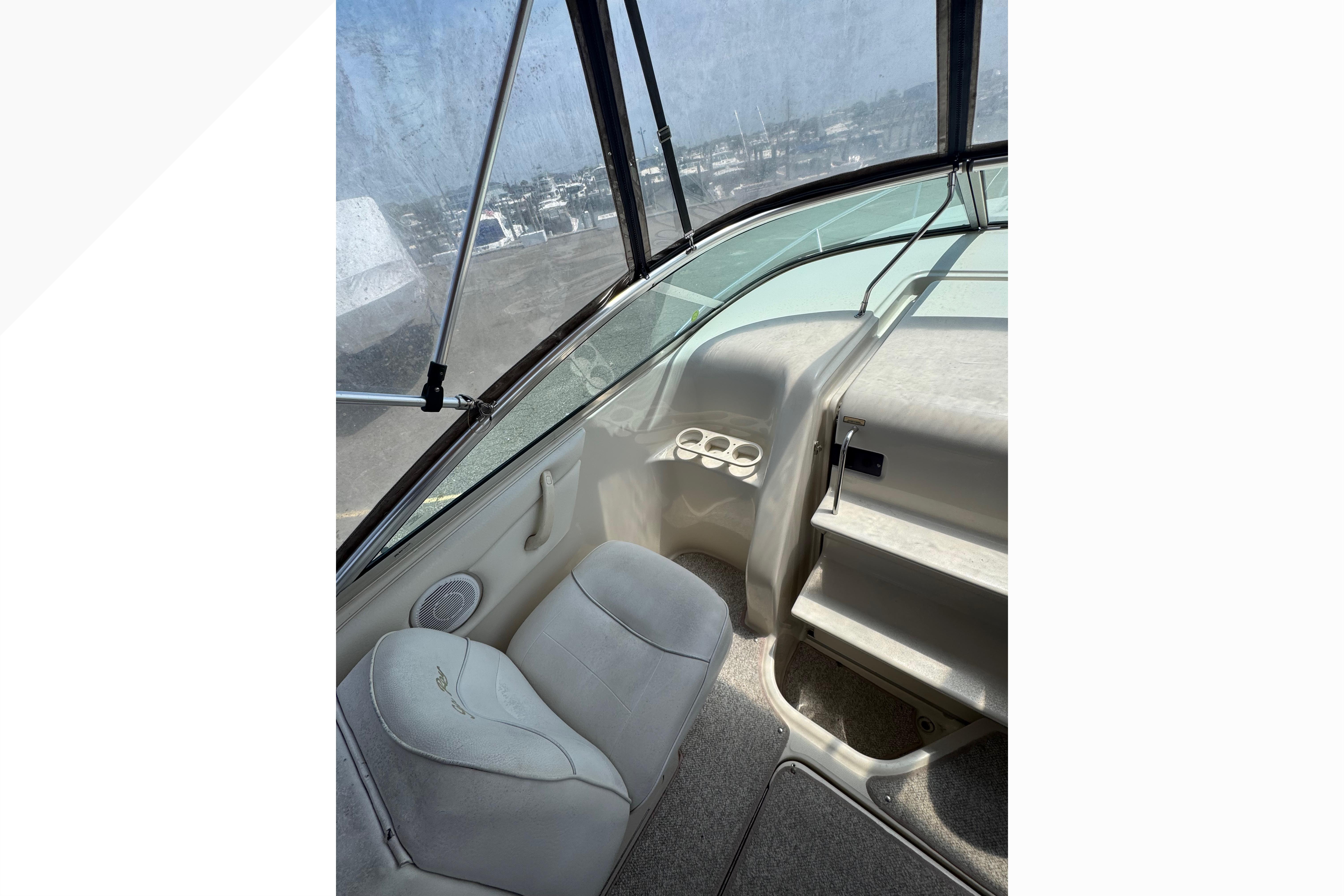 Interior view of 2001 Sea Ray 245 Weekender boat, featuring seating and dashboard.