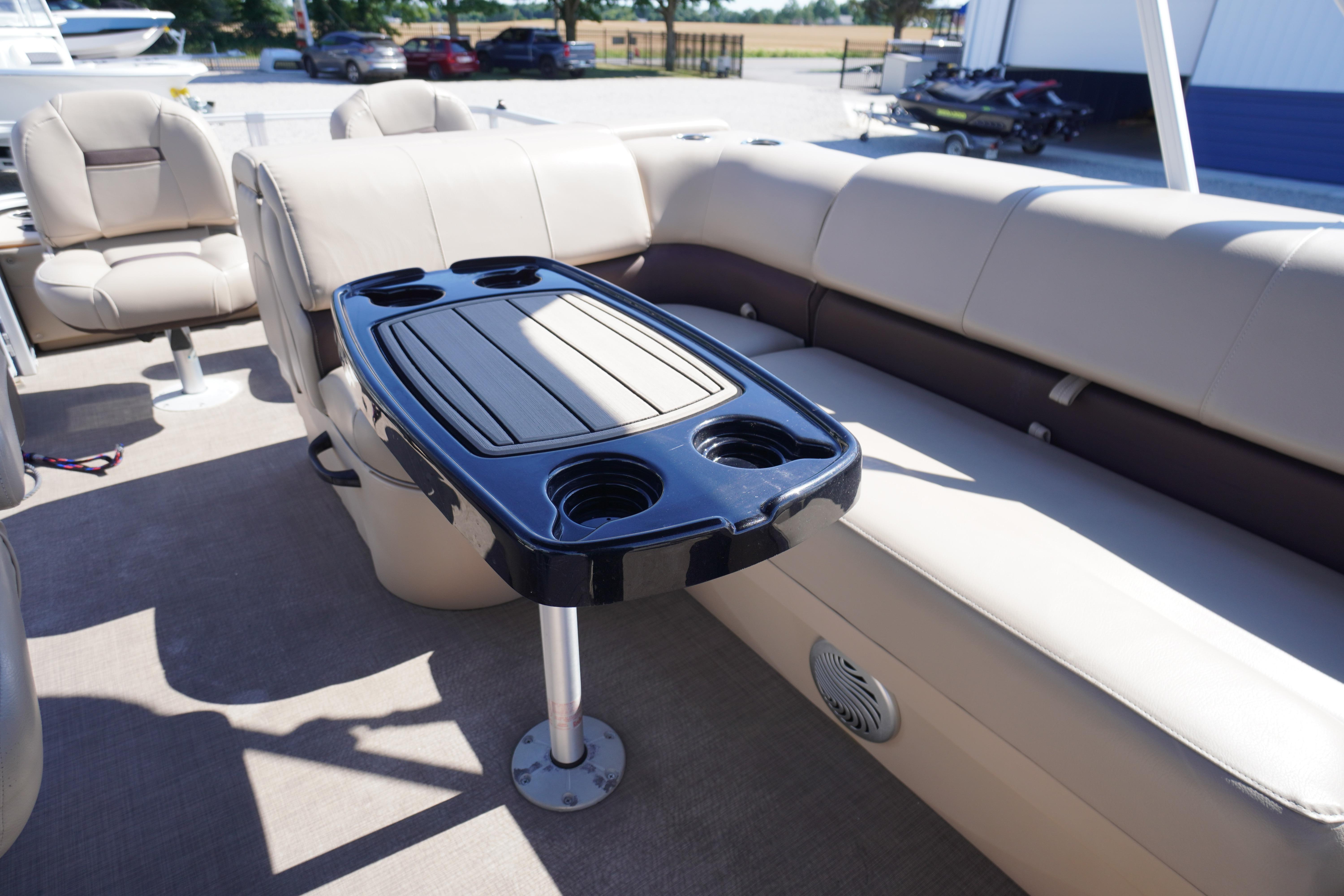 2019 SUNTRACKER Fishin' Barge 22 DLX interior with seating and table.