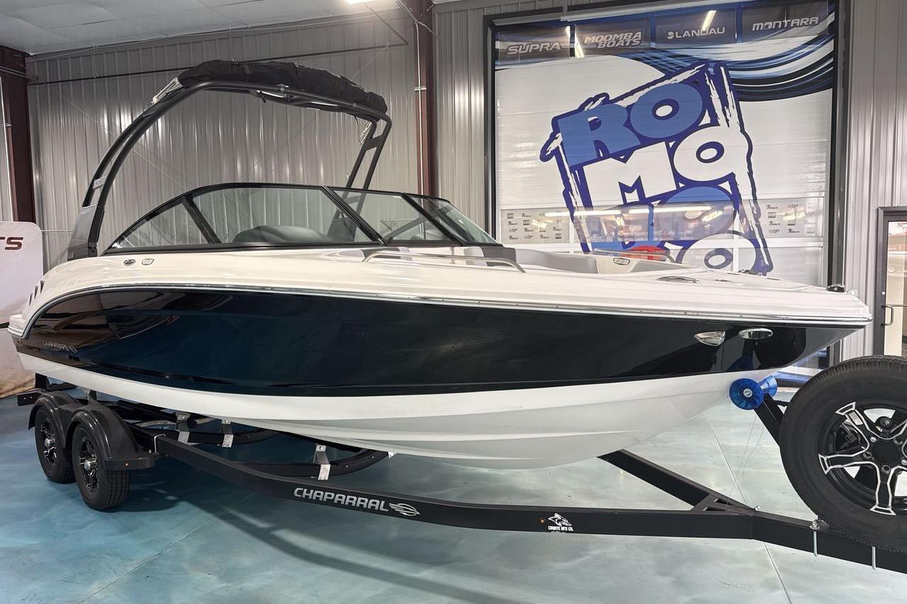 A 2026 Chaparral 23 SSi boat on a trailer inside a showroom.