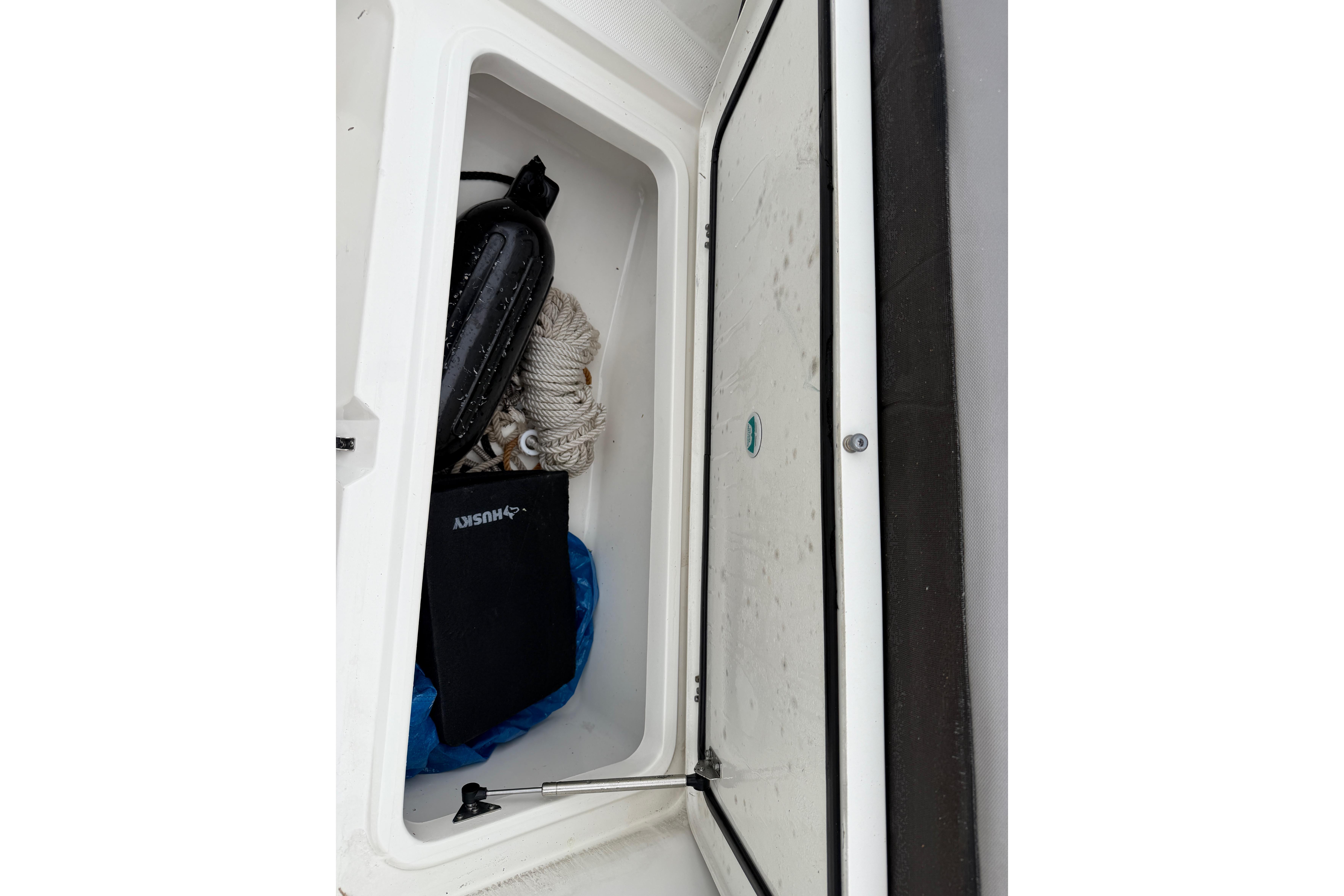 Storage compartment on a 2019 World Cat 230 DC boat with ropes and accessories.
