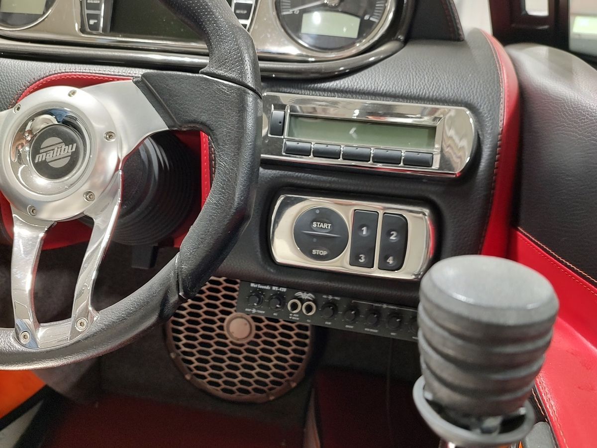 Close-up of the control area in a 2009 Malibu Wakesetter 23 LSV, featuring steering wheel and controls.