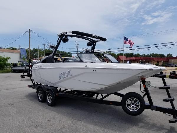 2023 ATX Surf Boats 20 Type-S on trailer, white exterior, American flag in background.