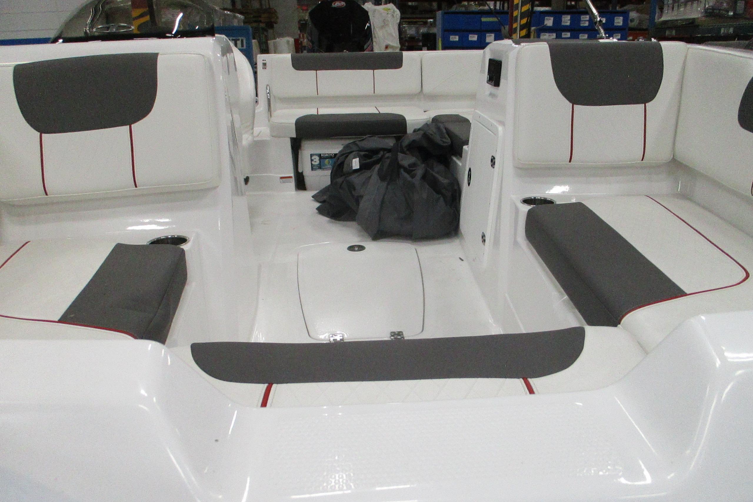 2024 Tahoe 1950 boat interior with gray and white seating, cup holders, and storage compartments.