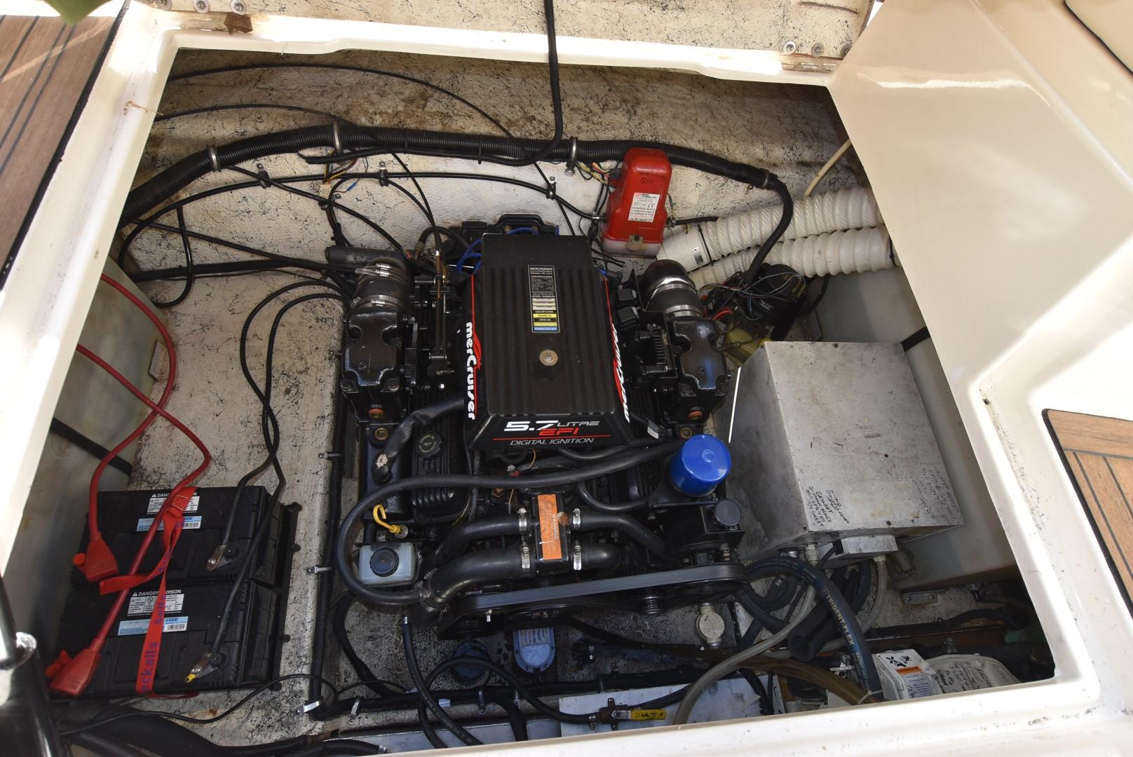Engine compartment of a 1999 Rinker 270 Fiesta Vee boat with visible MerCruiser engine.