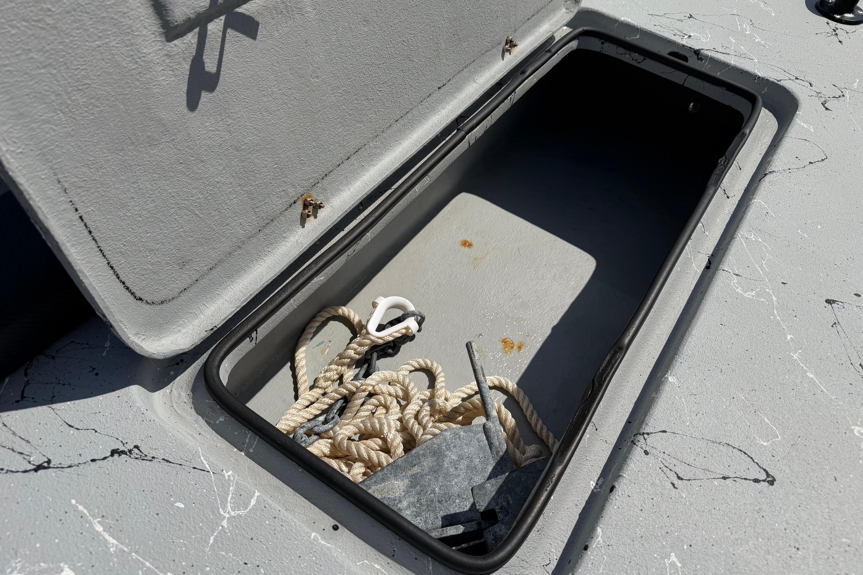 Open storage compartment on 2023 Haynie 23 Super Cat boat with rope and anchor.