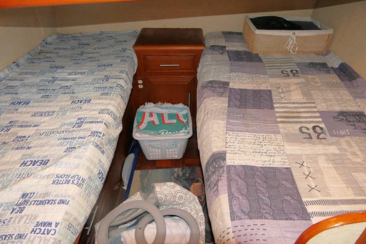 1986 Ocean Alexander 39 Sedan cabin with twin beds and wooden nightstand.