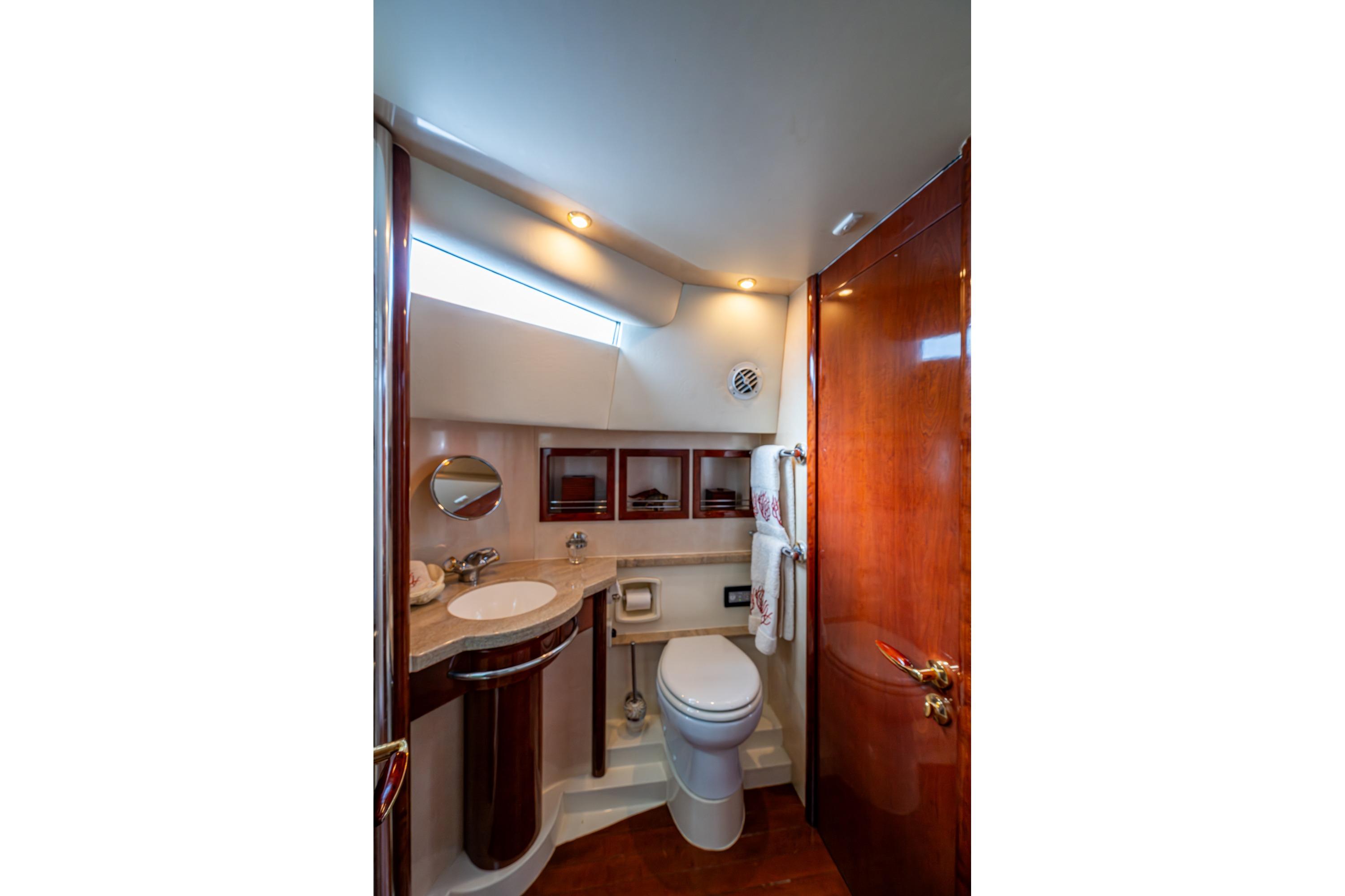 Luxurious bathroom interior of 2000 Fairline Squadron 52 yacht with elegant wood finishes.