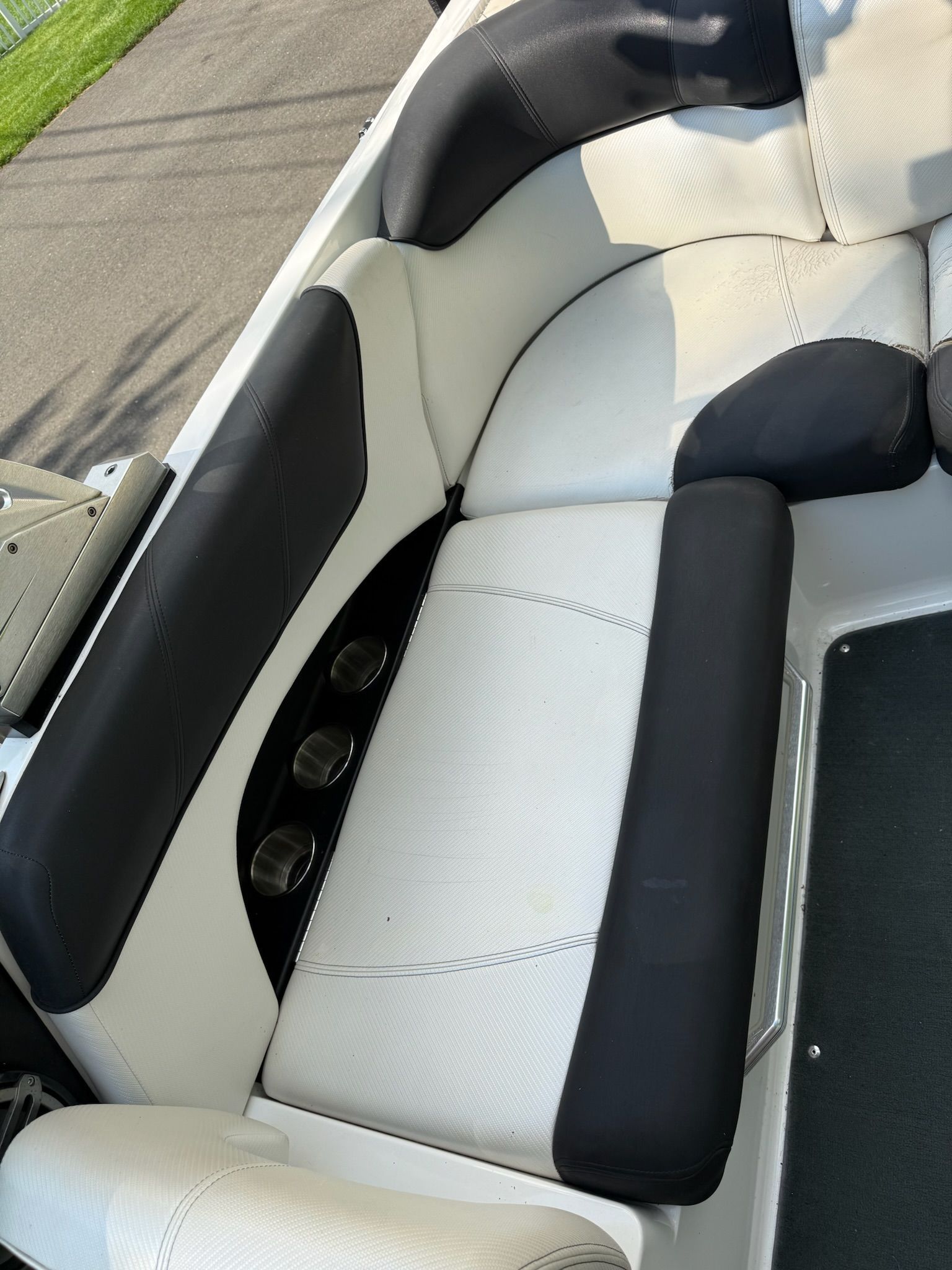 The 2013 MasterCraft X-25 features a stylish, cushioned seating area with black and white upholstery.