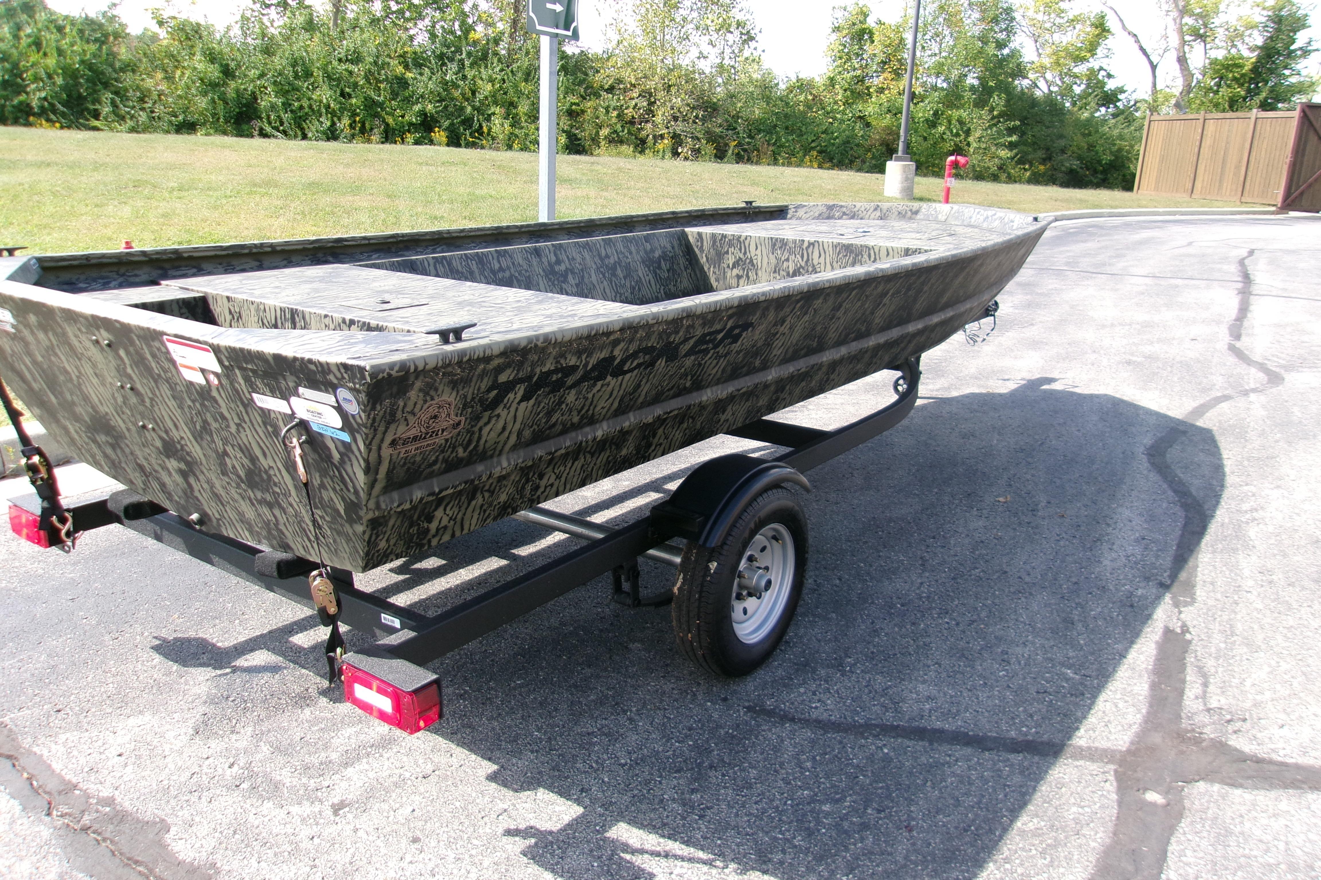 2026 Tracker Grizzly 1648 Utility boat on trailer, parked outdoors.