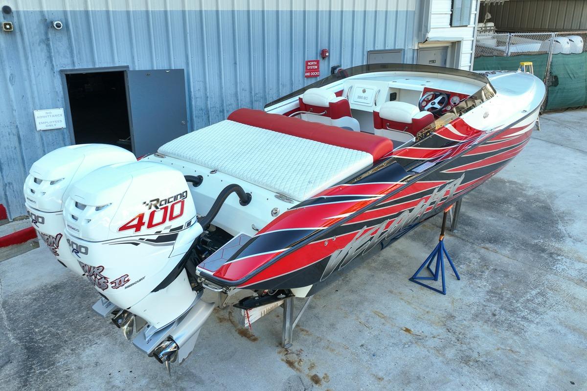 2022 Velocity 290sc speedboat with twin 400 horsepower engines, vibrant red and black design.