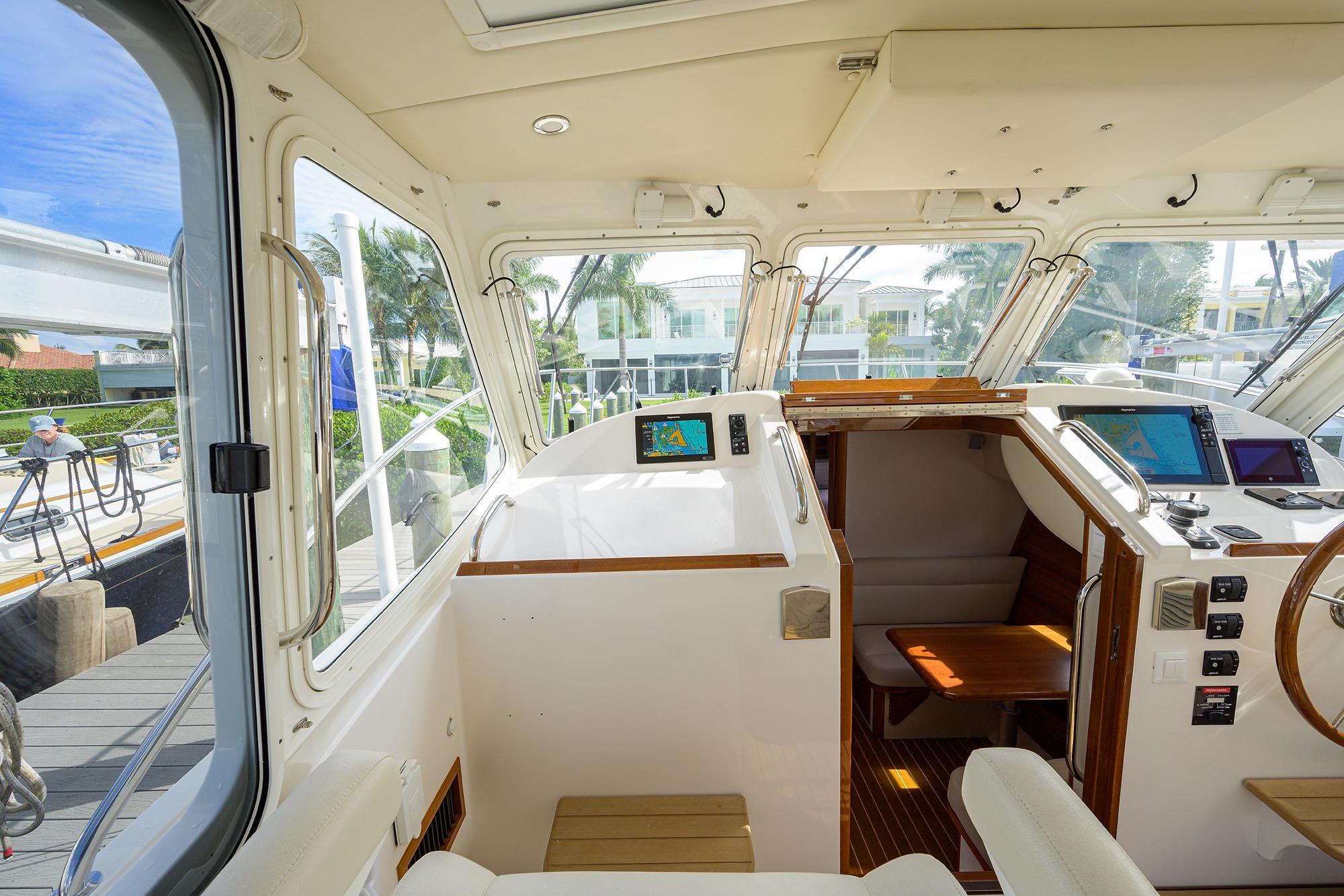 Interior view of 2019 MJM 43z yacht cockpit with navigation equipment and seating.