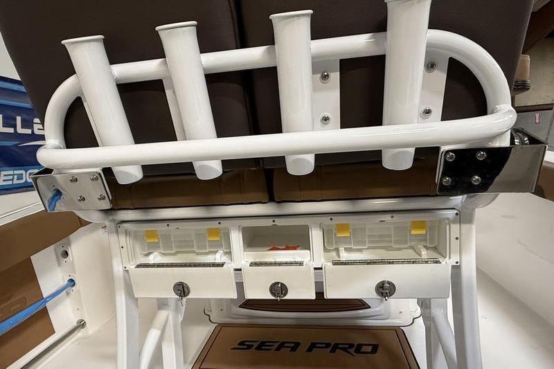 2026 Sea Pro 242 Center Console boat with rod holders and storage compartments.