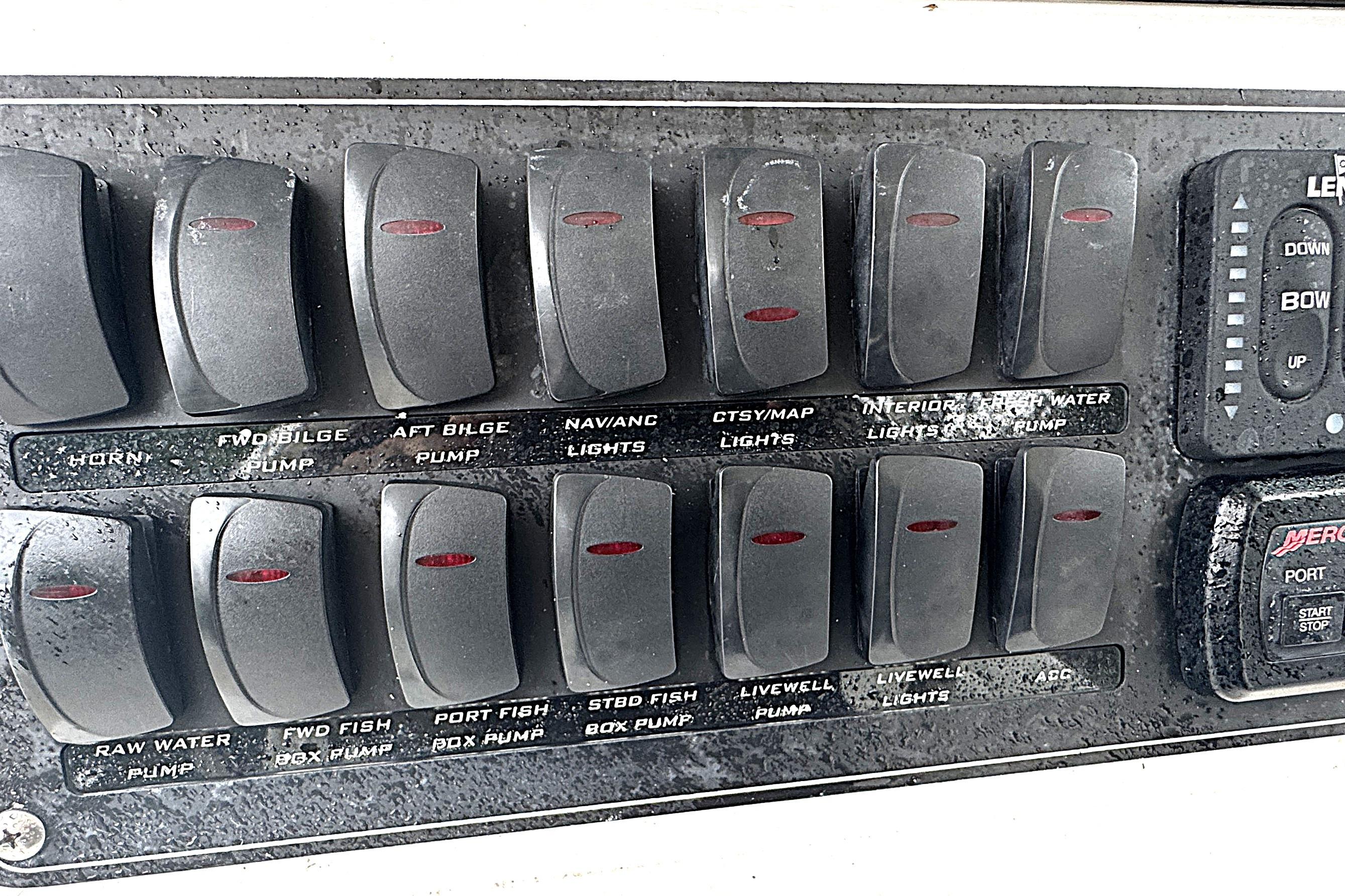Control panel of a 2014 Boston Whaler 250 Outrage boat with labeled switches.
