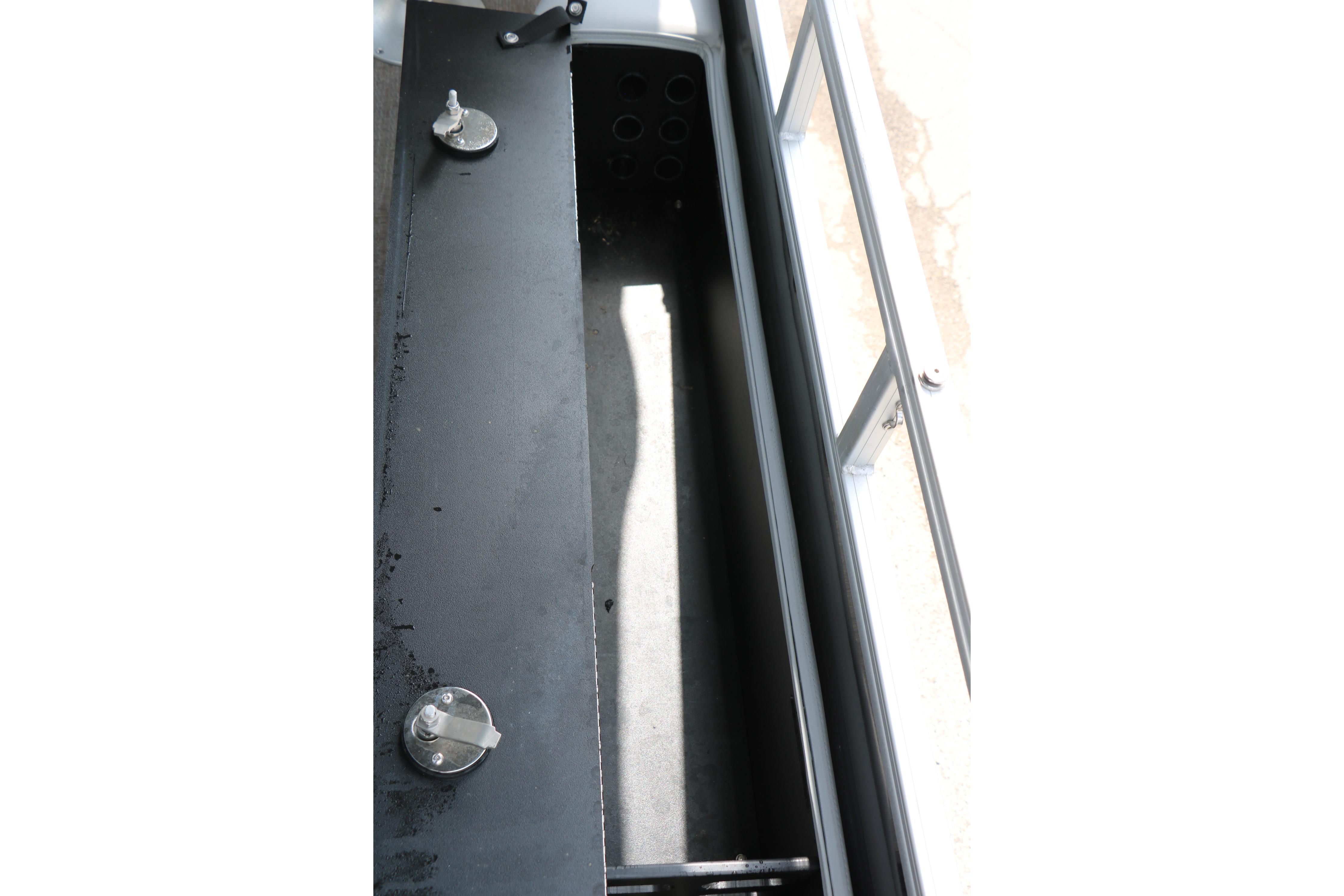 Storage compartment of 2021 Ranger 223FC boat, featuring secure latches and spacious interior.