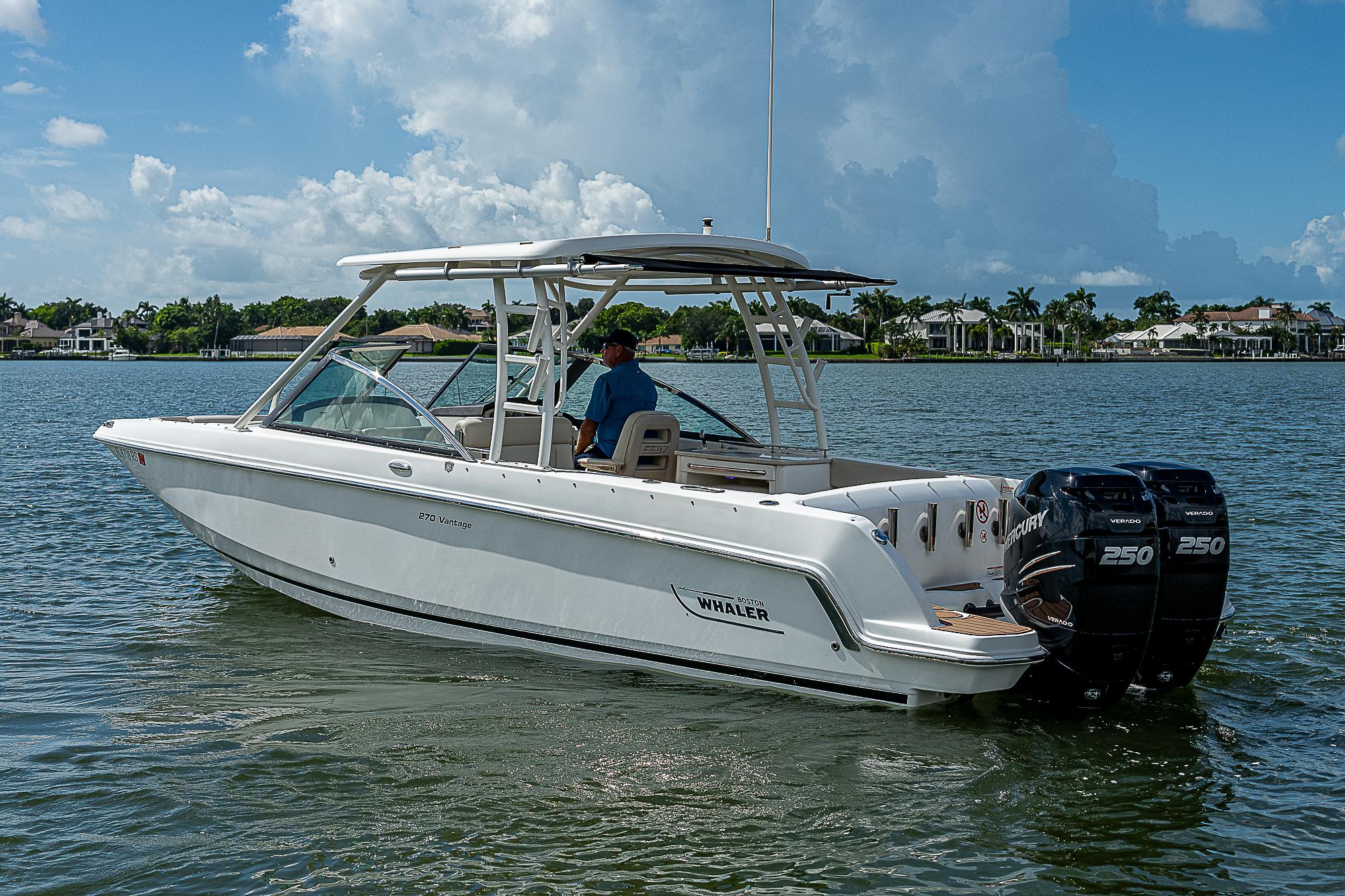 2018 Boston Whaler 270 Vantage boat on calm water under a blue sky.