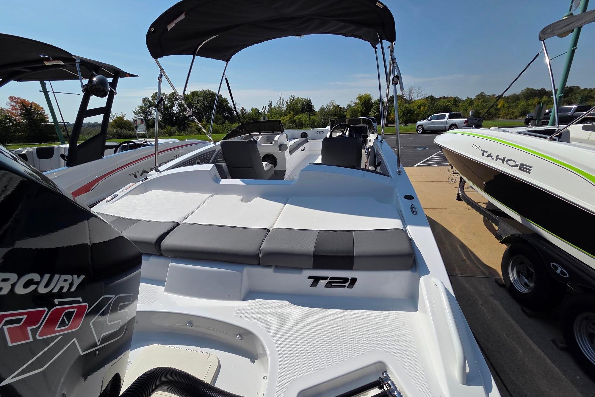 2025 Tahoe T21 boat with canopy, parked on trailer, featuring sleek design and comfortable seating.