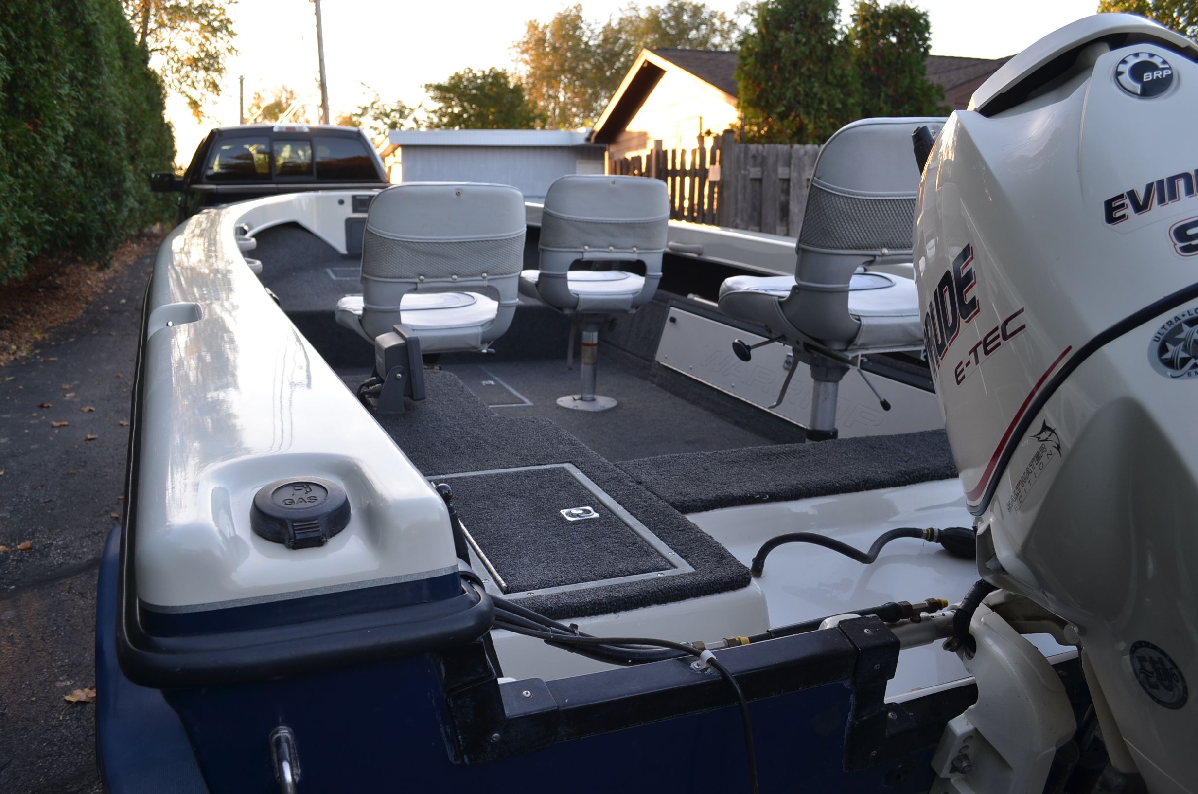 A 2000 Warrior V1890 Backtroller Eagle with Evinrude motor, two seats, and a spacious deck.