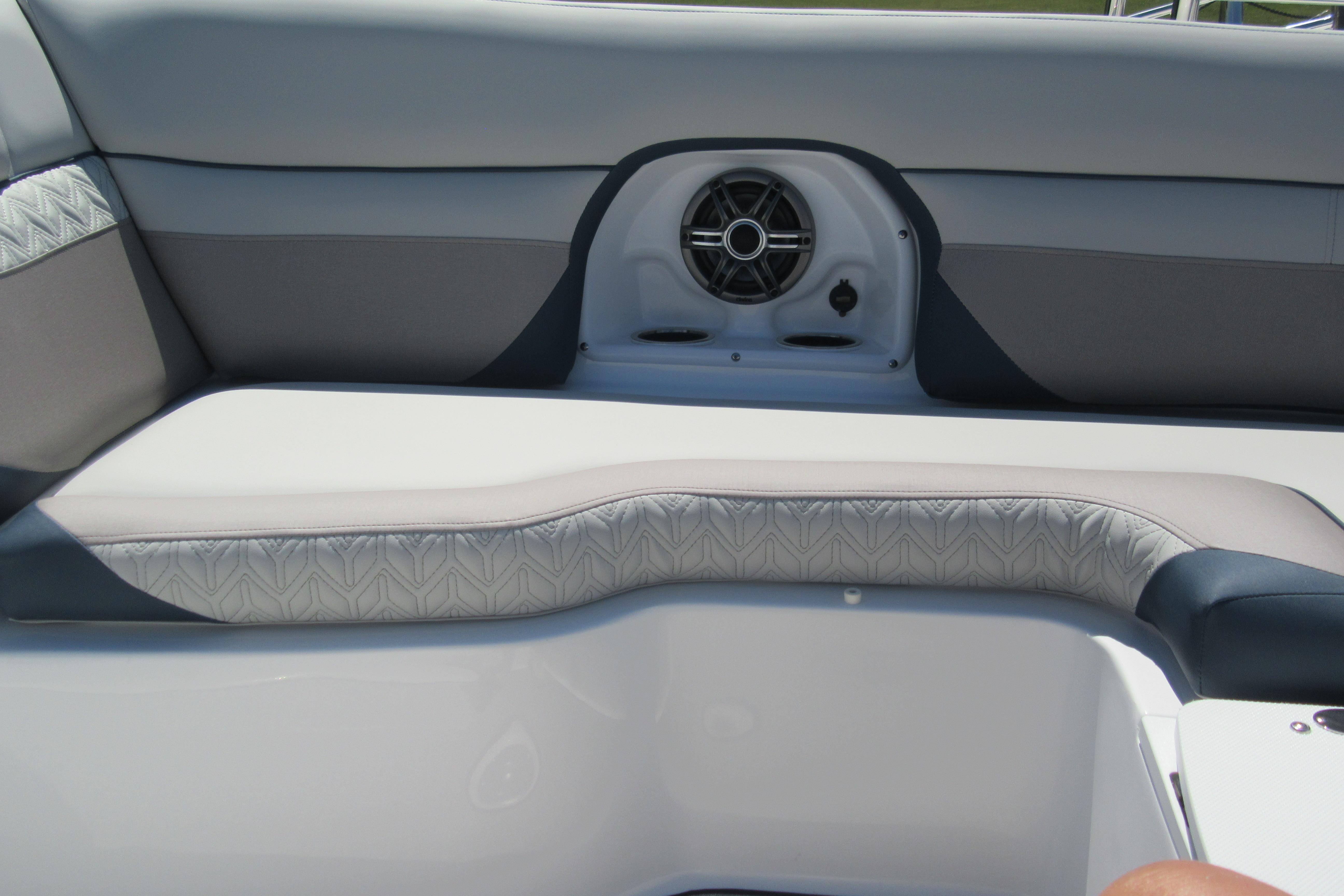 Interior seating of 2027 Hurricane SunDeck 2486 OB boat with speaker system.