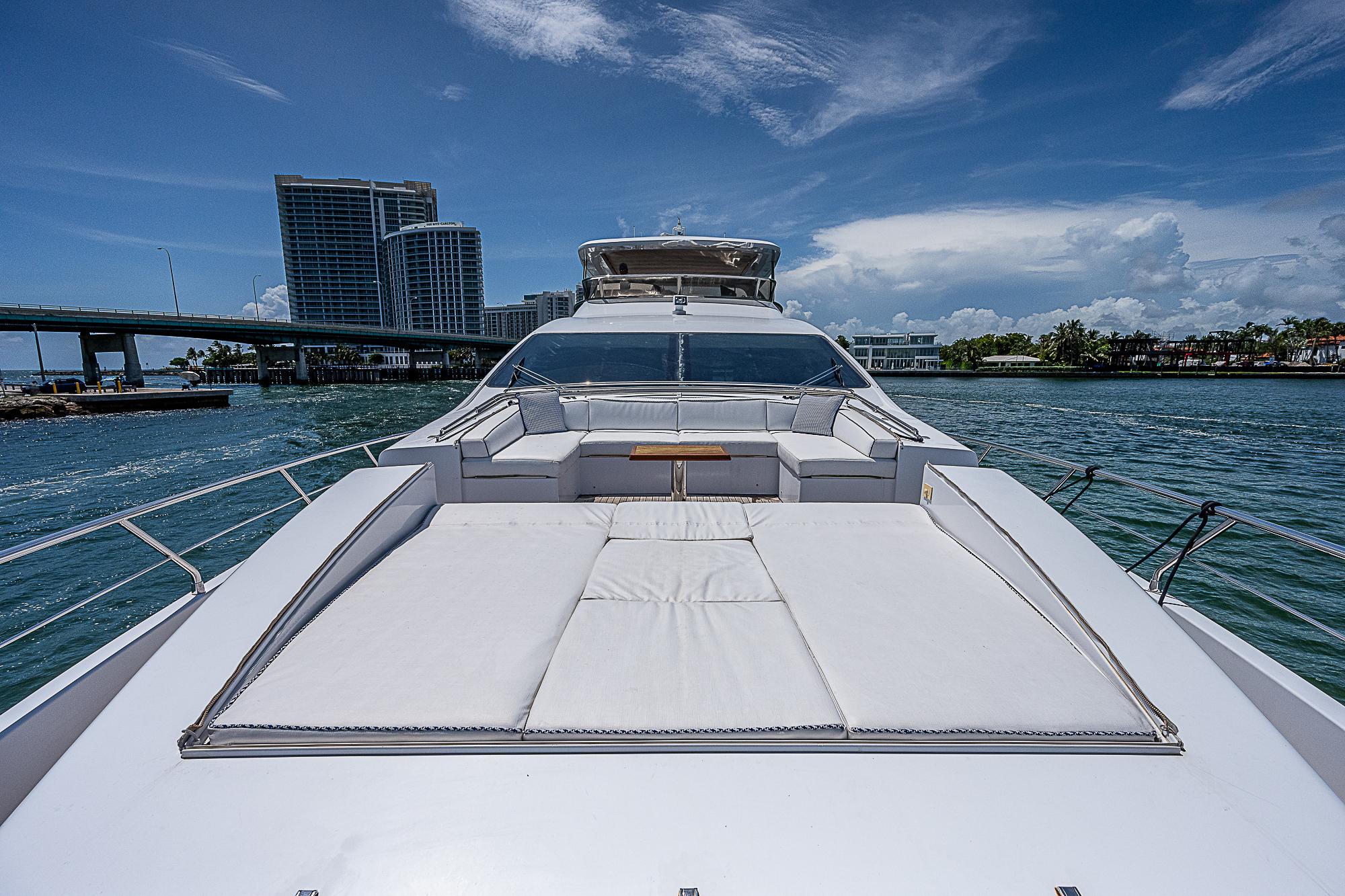 Luxurious 2011 Azimut 82 yacht on water with city skyline backdrop.
