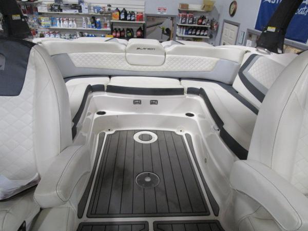 Interior of 2017 Larson 292 LXI boat with white seating and black flooring.